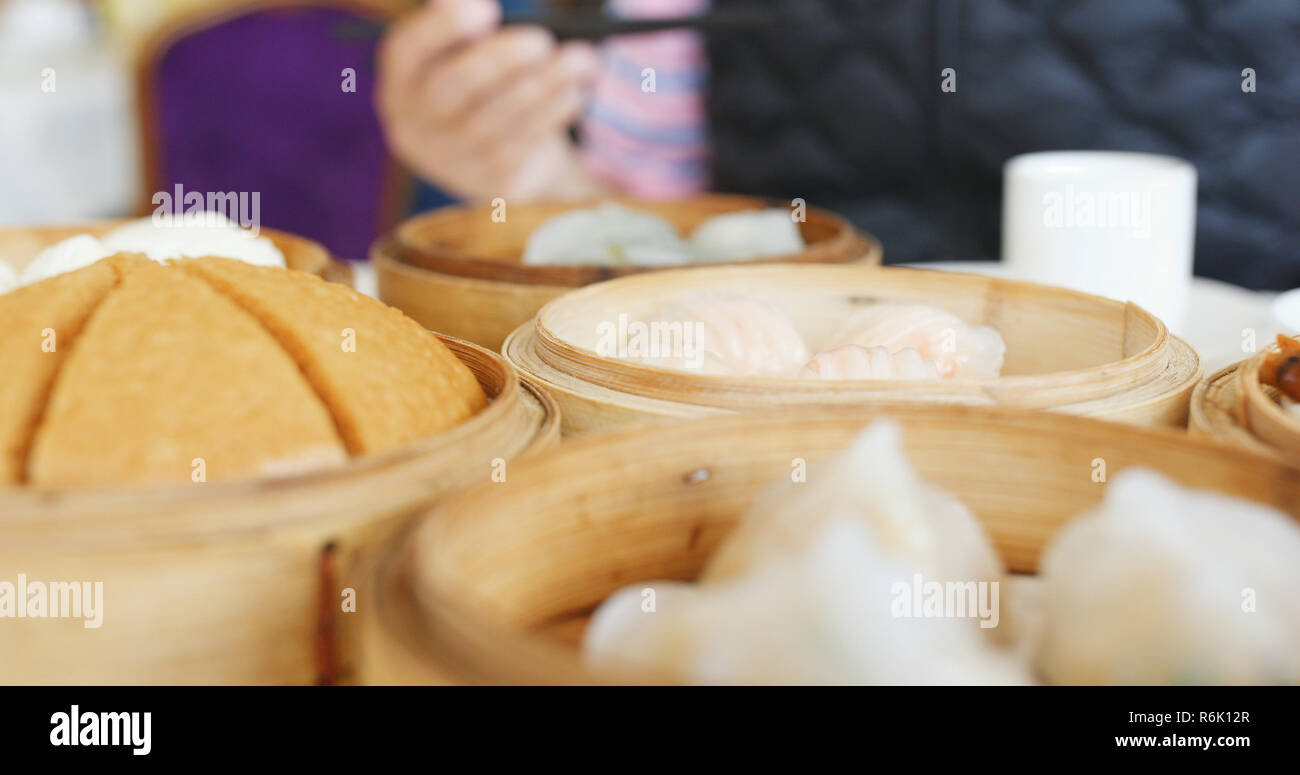 Eating steamed chinese dim sum Stock Photo