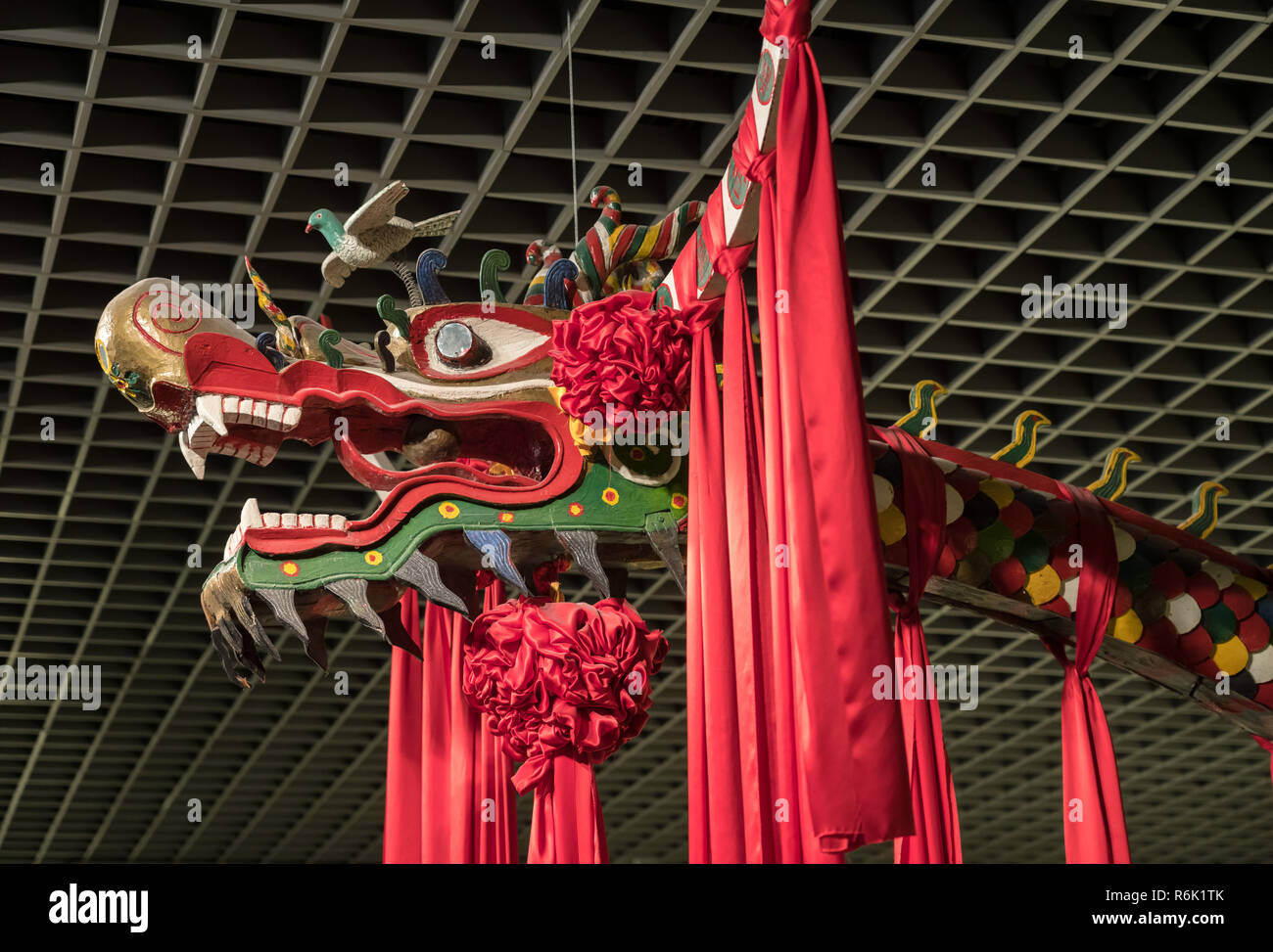 Artistic wooden dragon hanging from ceiling of museum Stock Photo