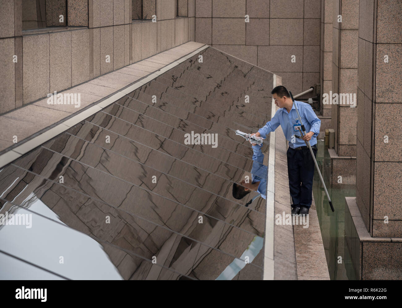 Cleaning windows at Shanghai Museum of Chinese Art building exterior Stock Photo