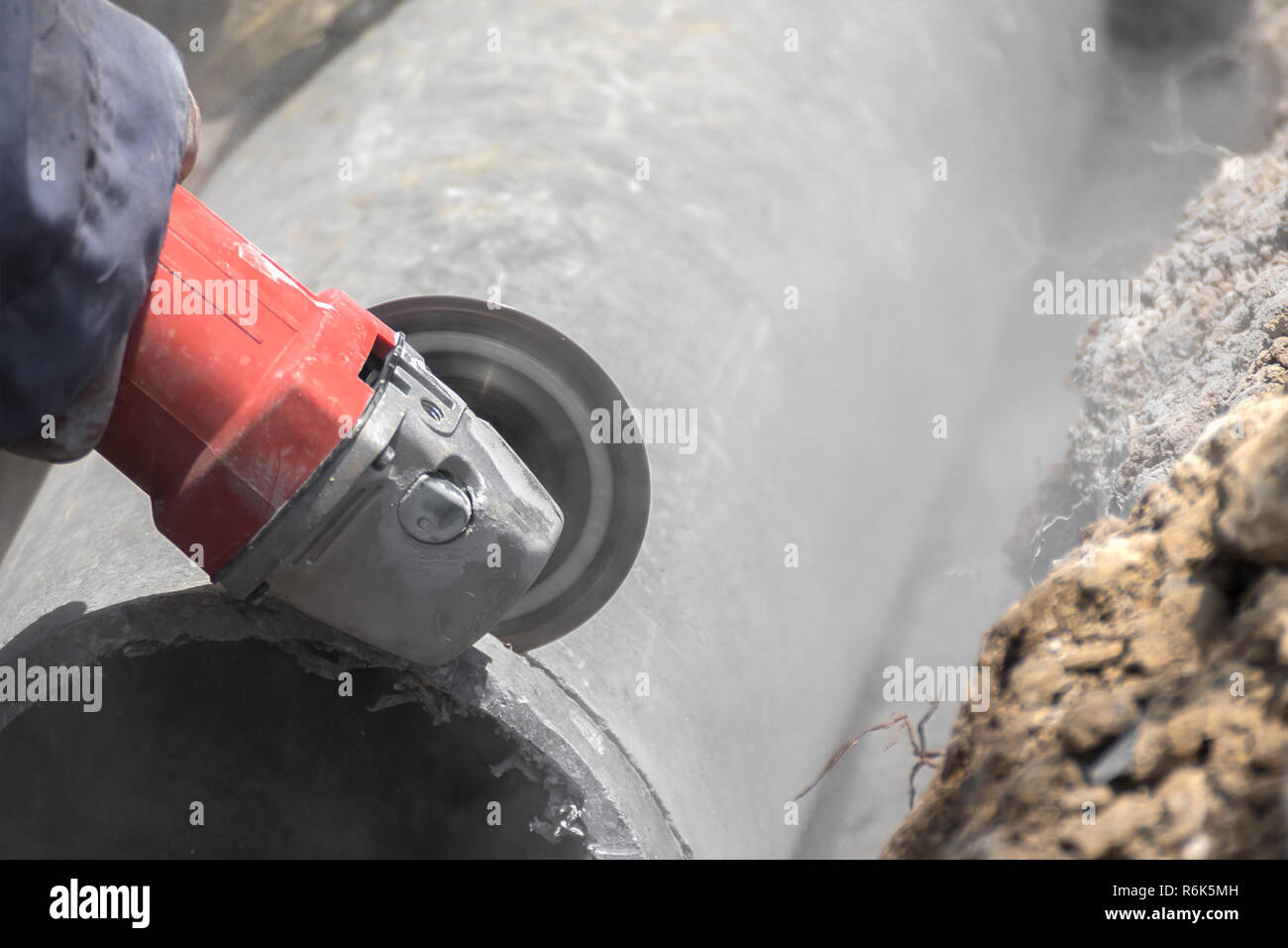 Plumbers cutting concrete water pipes Stock Photo Alamy
