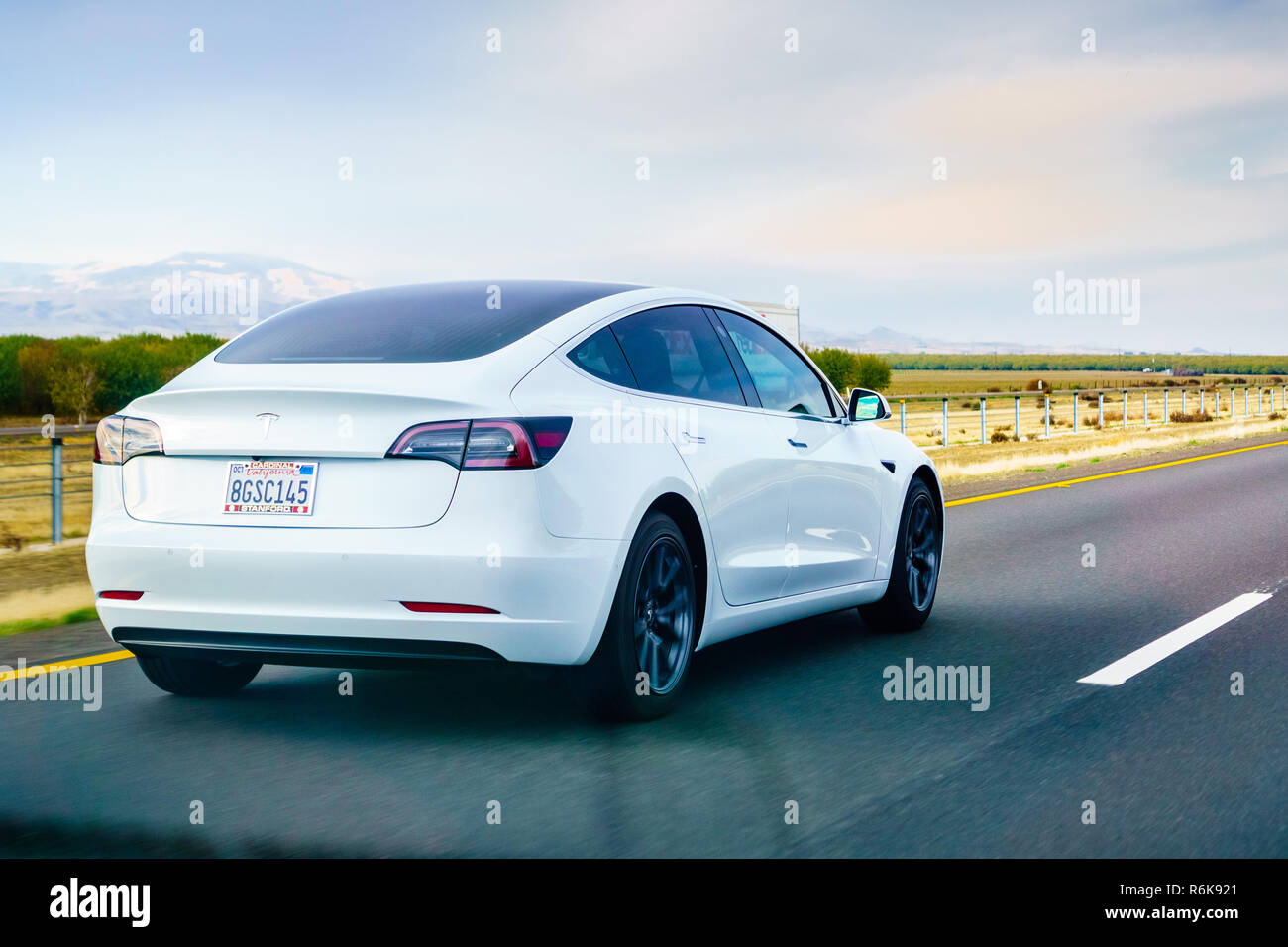 December 3, 2018 Los Angeles / CA / USA - White Tesla Model 3 driving on the freeway Stock Photo