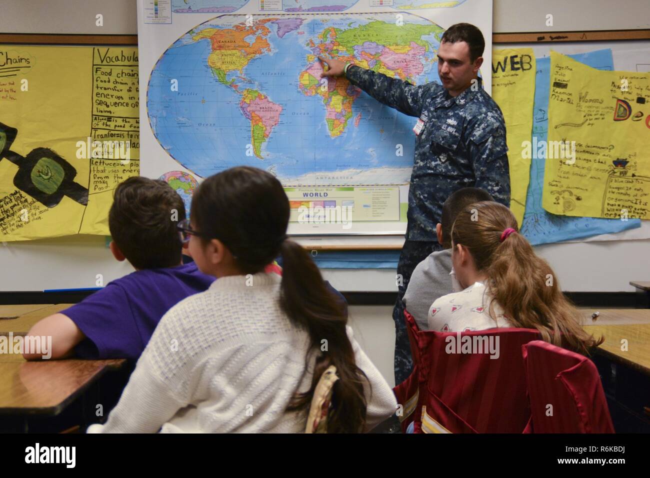 IRVING, Texas (May 19, 2017) Machinist Mate 2nd Class Adam Al Sharif, a recruiter assigned to Navy Recruiting District (NRD) Dallas, shows everywhere he has traveled with the U.S. Navy to students at Thomas Haley Elementary School during Career Day. NRD Dallas encompasses 150,000 square miles that includes Northwest Texas and Oklahoma. Stock Photo