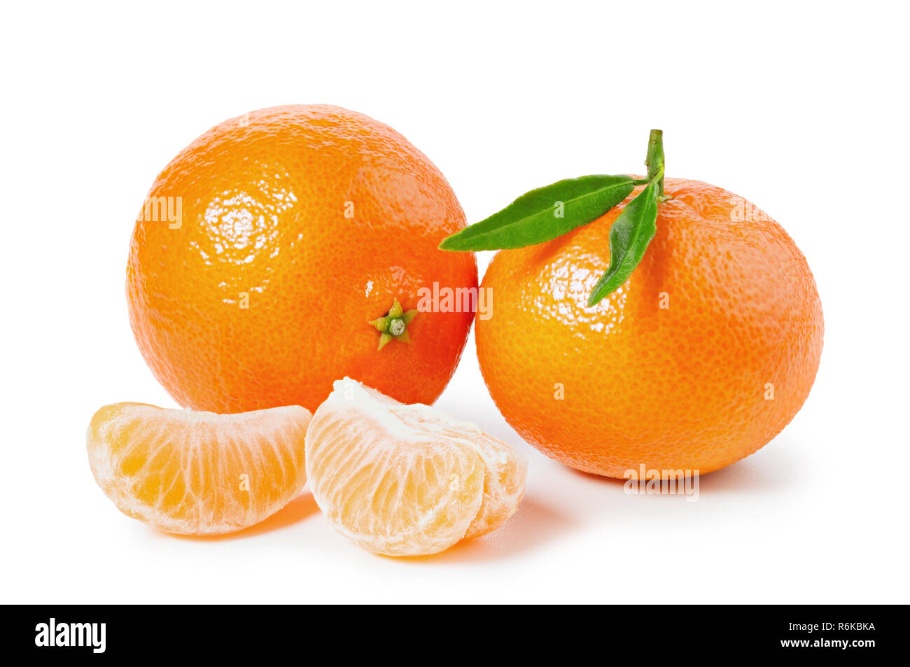 Tangerines or clementines with green leaf and slices isolated on white