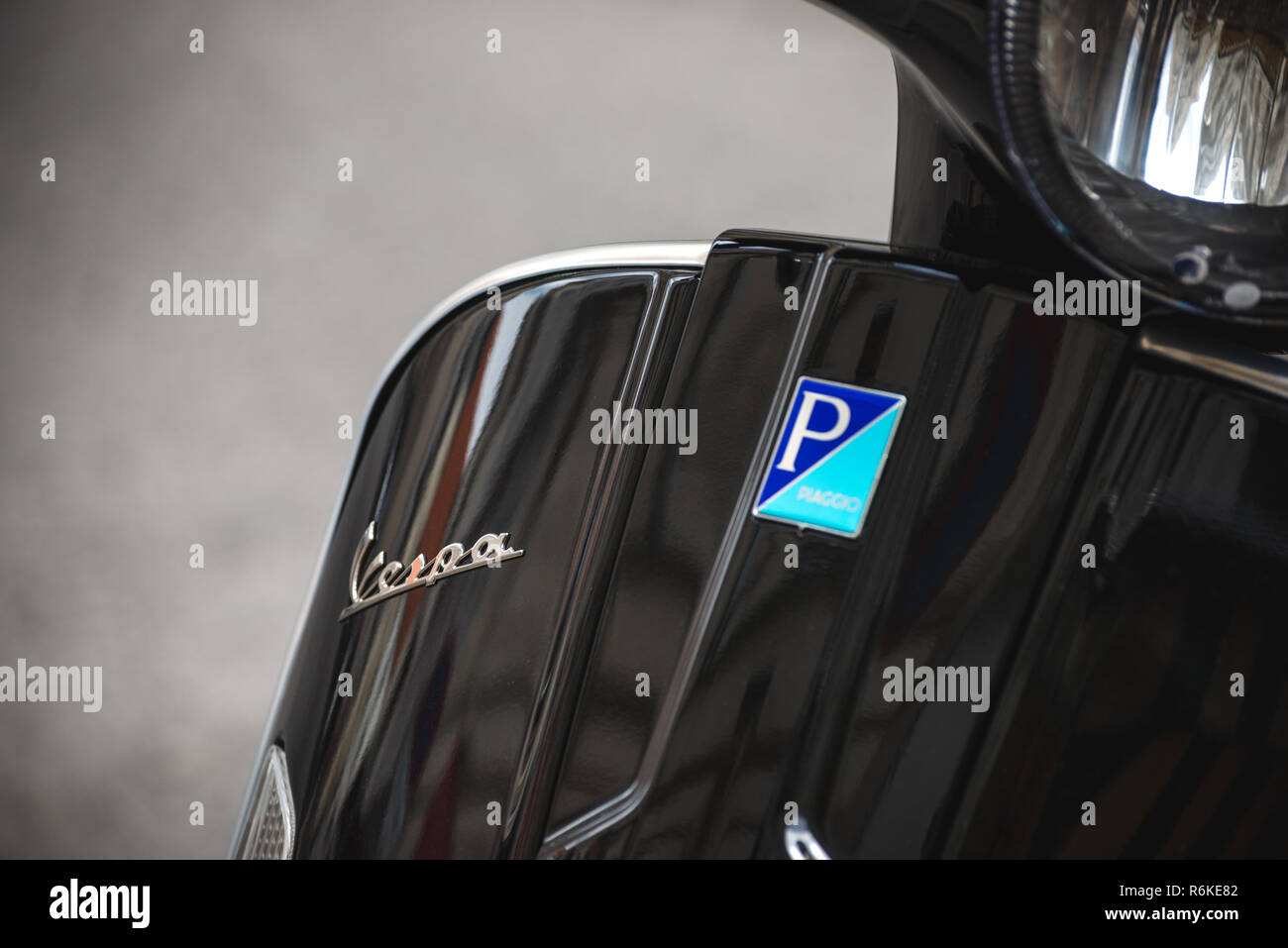 Vienna, Austria - July 18, 2018: Close up detailed view of modern black Vespa scooter with logo by Piaggio Stock Photo