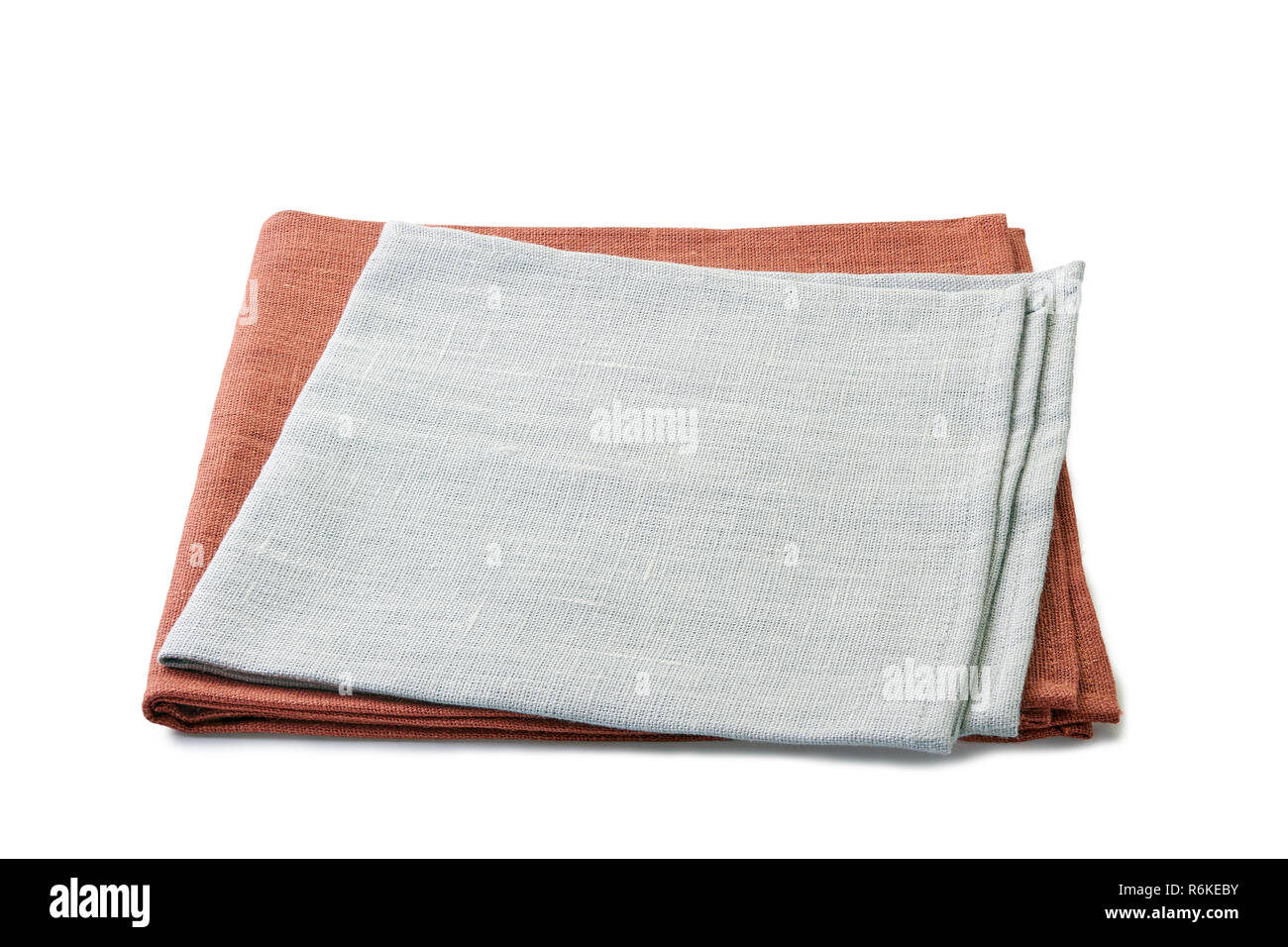 Folded brown and gray textile napkins stacked on white background Stock Photo