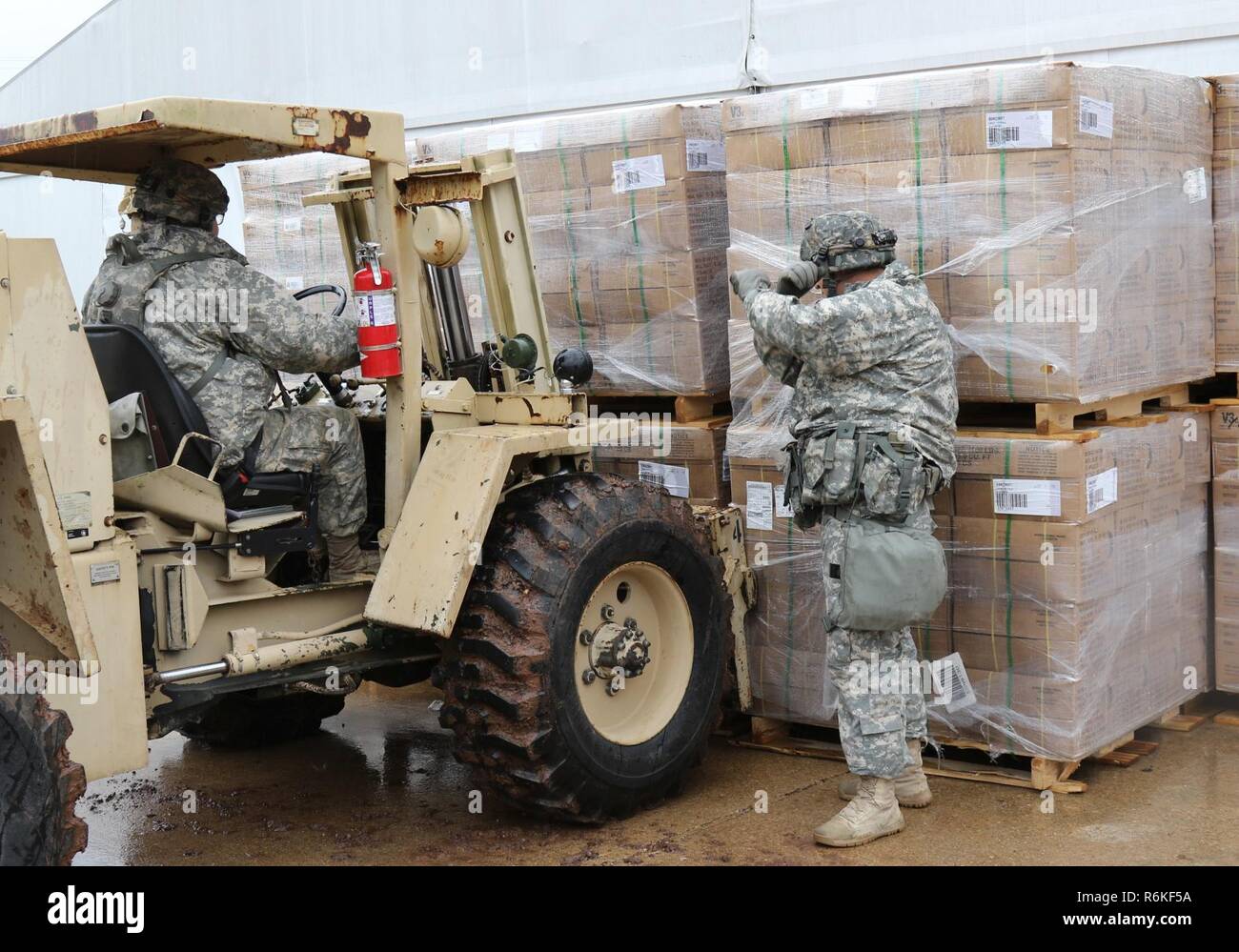 U.S. Army Reserve Soldiers with the 79th Quartermaster Company based in Houston, Texas, move pallets of Meals Ready-to-Eat during Joint Readiness Training Center (JRTC) Rotation 17-07, at Fort Polk, Louisiana, May 5 to 26, 2017.  JRTC provides America’s military forces relevant, rigorous, multi-echelon training in a decisive action and mission rehearsal exercise environment to develop adaptive leaders, confident units, and robust capabilities across the range of military operations achieving Army readiness. Stock Photo
