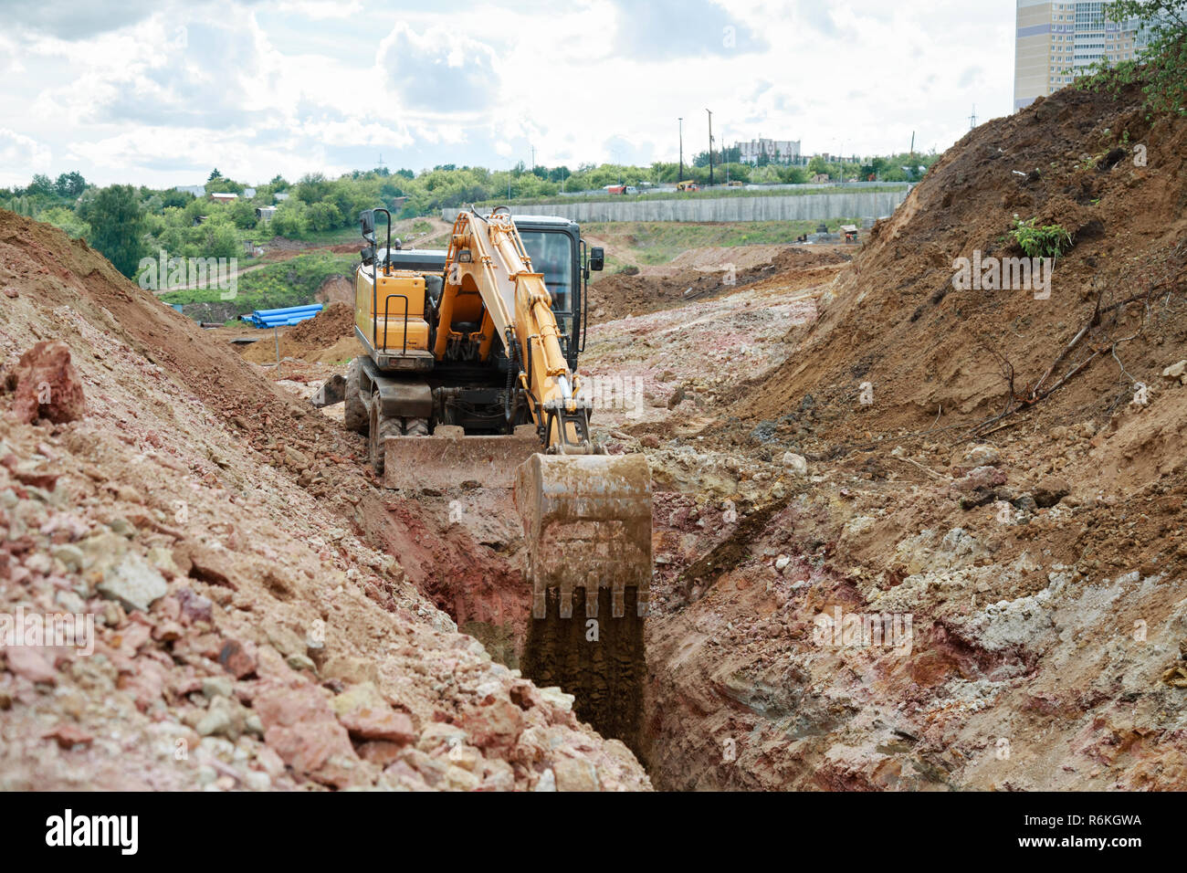 Excavator digging a trench for the pipeline. Excavation Stock Photo - Alamy