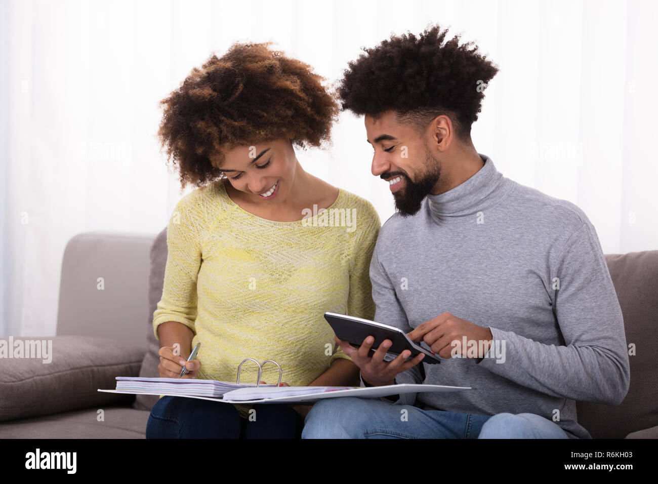 Couple Calculating Bill With Calculator Stock Photo Alamy