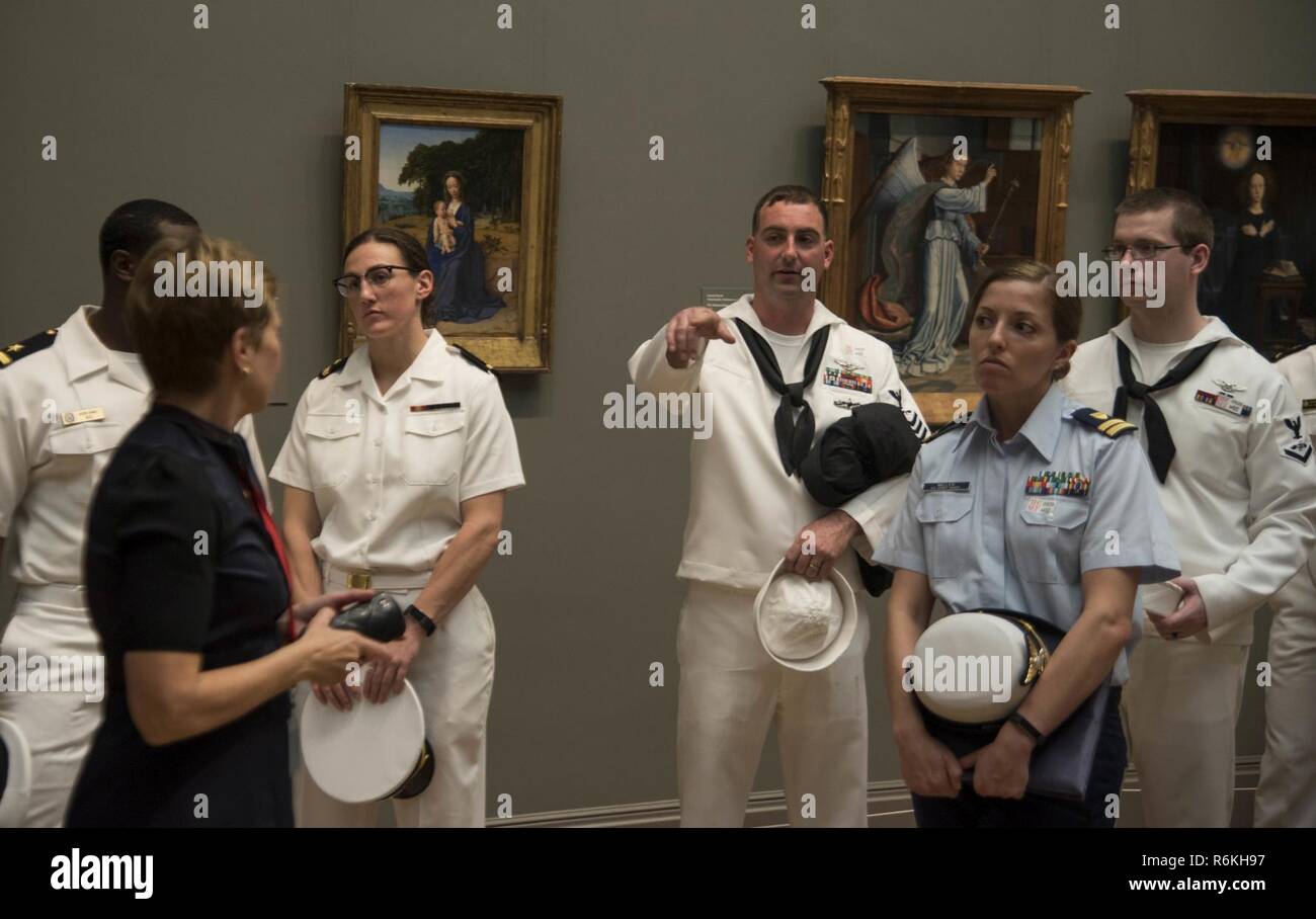 NEW YORK (May 25, 2017) Sailors assigned to the guided-missile cruiser USS Monterrey (CG 61), Coast Guardsmen, and Marines attend a highlight tour of the Metropolitan Museum of Art in New York City. Fleet Week New York, now in its 29th year, is the city’s time honored celebration of the sea services. It is an unparalleled opportunity for the citizens of New York and the surrounding tri-state area to meet Sailors, Marines and Coast Guardsmen, as well as witness firsthand the latest capabilities of today’s maritime services. Stock Photo