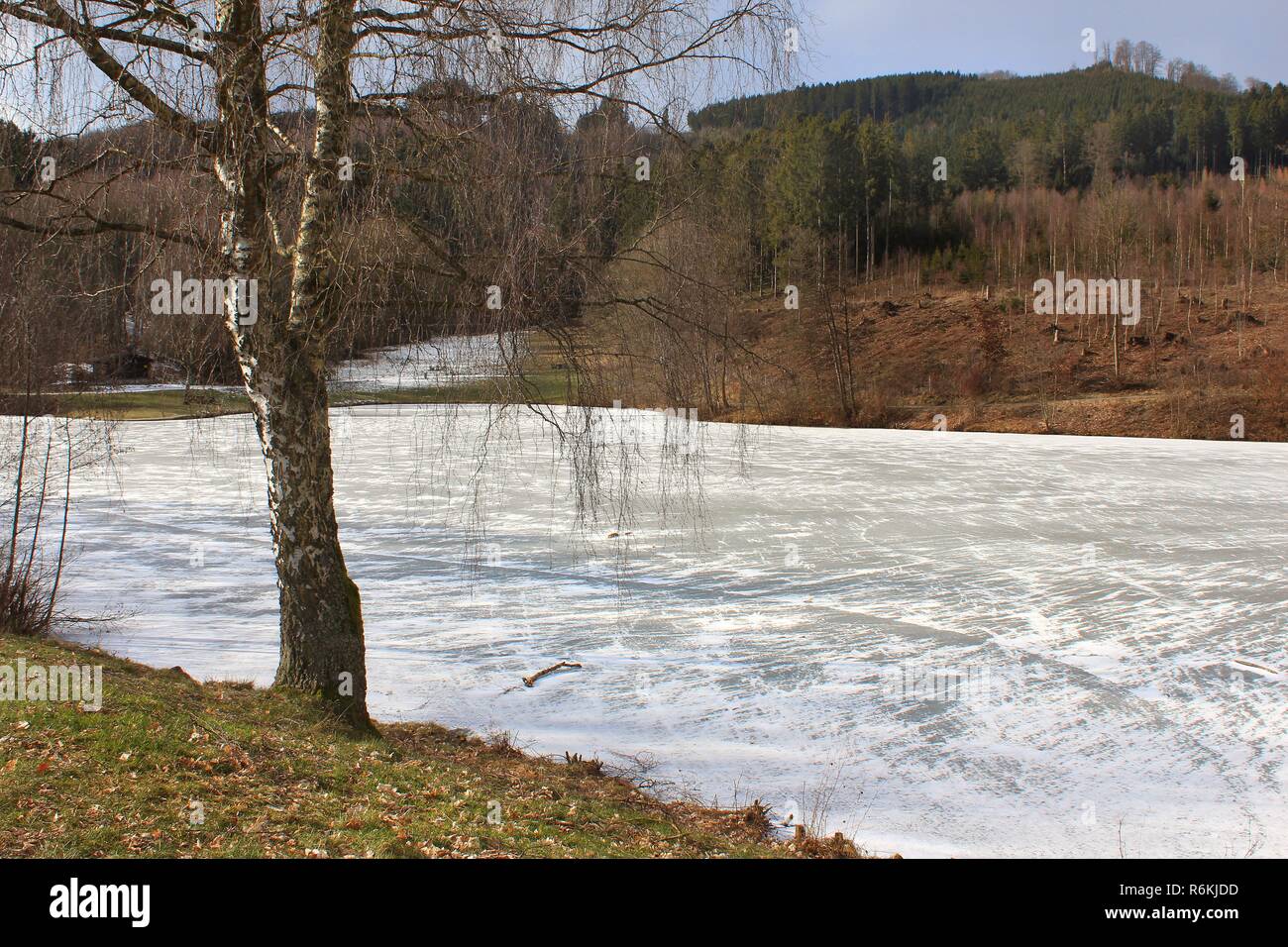 thin ice sheet on the frozen esmecke reservoir at eslohe-wenholthausen in hochsauerland,north rhine-westphalia Stock Photo