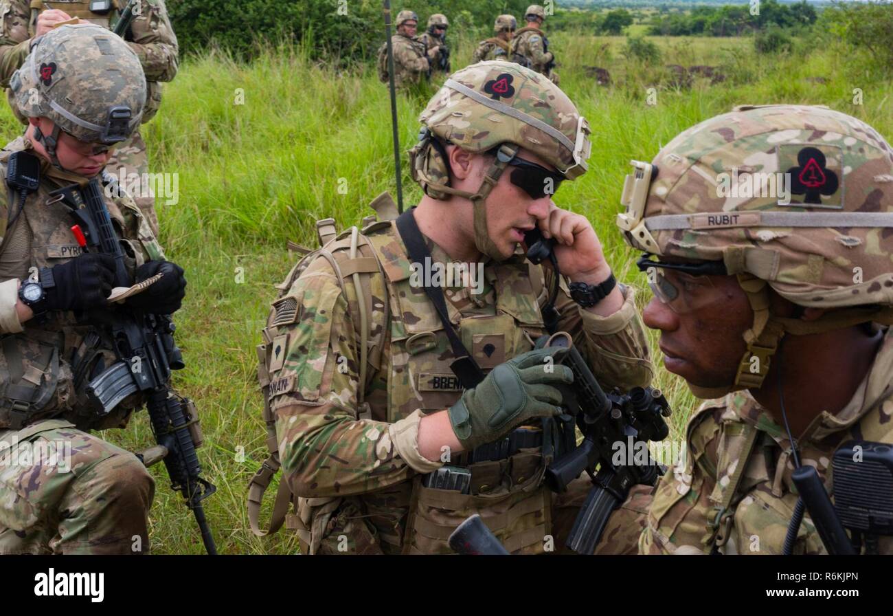 A U.S. Soldier assigned to the 1st Battalion, 506th Infantry Regiment, 1st Brigade Combat Team, 101st Airborne Division communicates with their headquarters via a radio during a Live Fire Exercise at Bundase Training Camp, Bundase, Ghana, May 26, 2017. United Accord (formerly Western Accord) 2017 is an annual, combined, joint military exercise that promotes regional relationships, increases capacity, trains U.S. and Western African forces, and encourages cross training and interoperability. Stock Photo