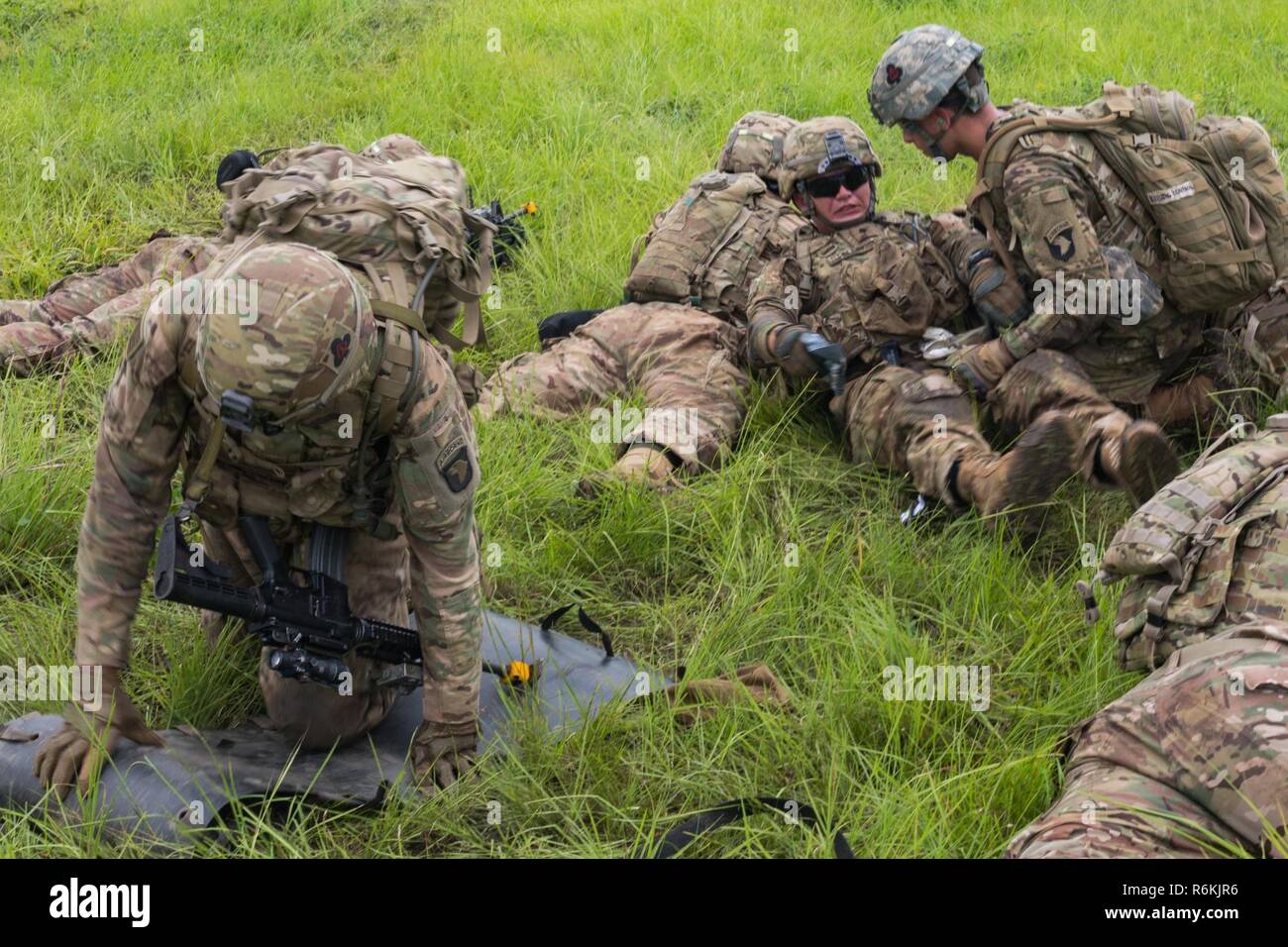 U.S. Soldiers assigned to the 1st Battalion, 506th Infantry Regiment, 1st Brigade Combat Team, 101st Airborne Division render aid to a notional casualty for a Live Fire Exercise during United Accord 2017 at Bundase Training Camp, Bundase, Ghana, May 26, 2017. United Accord (formerly Western Accord) 2017 is an annual, combined, joint military exercise that promotes regional relationships, increases capacity, trains U.S. and Western African forces, and encourages cross training and interoperability. Stock Photo