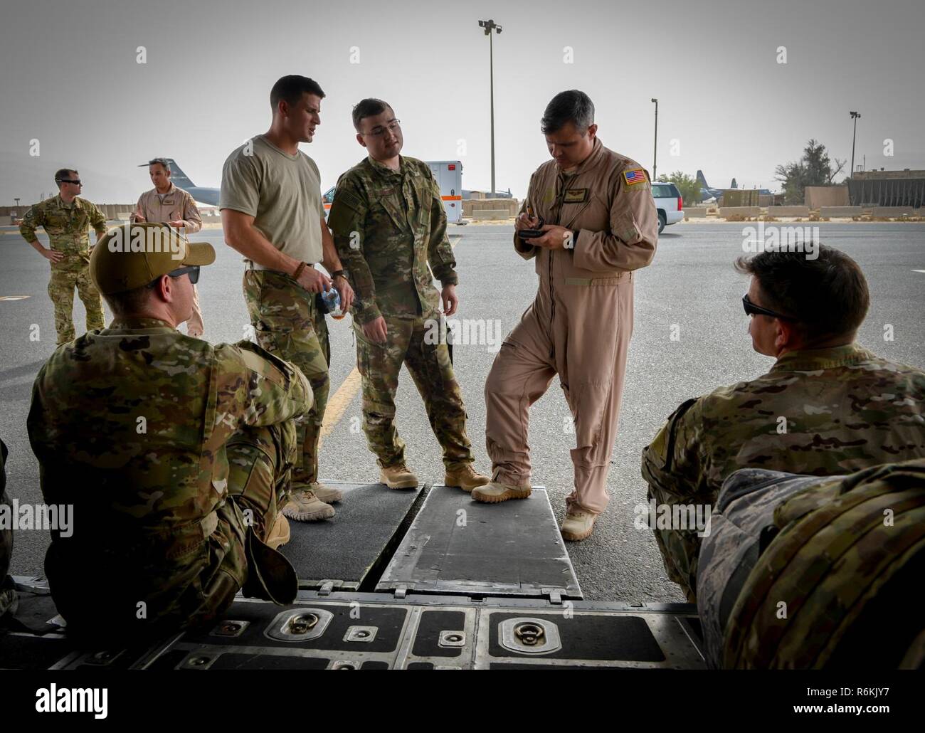 A pilot with the 746th Expeditionary Airlift Squadron holds a crew pre-flight brief while waiting on the arrival of patients May 19, 2017. The C-130 Hercules primarily performs the tactical portion of the airlift mission. The aircraft is capable of operating from rough, dirt strips and is the prime transport for airdropping troops and equipment into hostile areas. Stock Photo