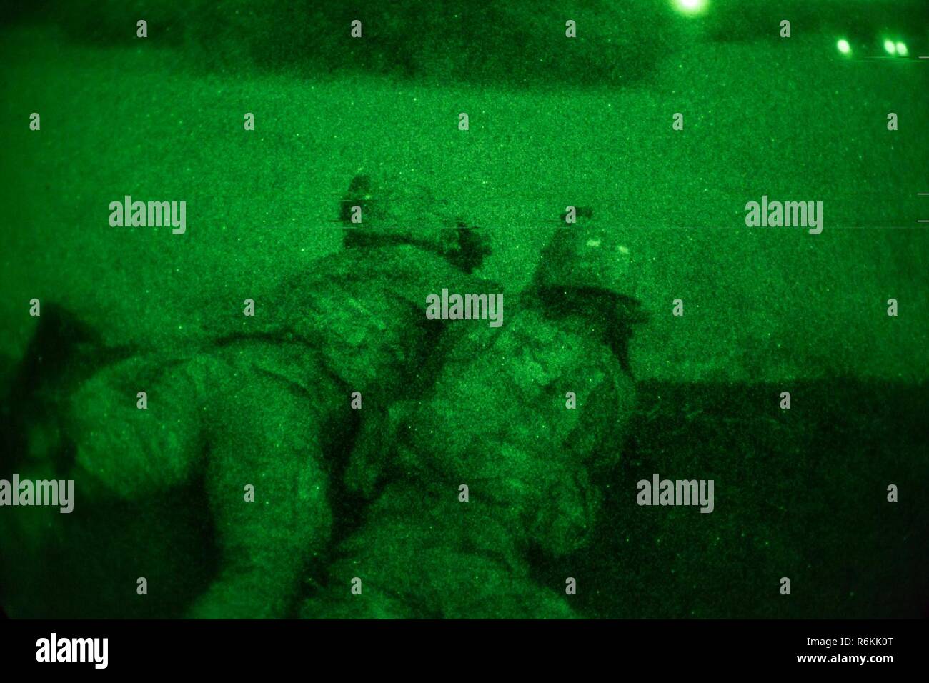 U.S. Soldiers assigned to the 1st Battalion, 506th Infantry Regiment, 1st, Brigade Combat Team, 101st Airborne Division engage a target during a Night Live Fire Exercise at Bundase Training Camp, Bundase, Ghana, May 26, 2017. United Accord (formerly Western Accord) 2017 is an annual, combined, joint military exercise that promotes regional relationships, increases capacity, trains U.S. and Western African forces, and encourages cross training and interoperability. Stock Photo