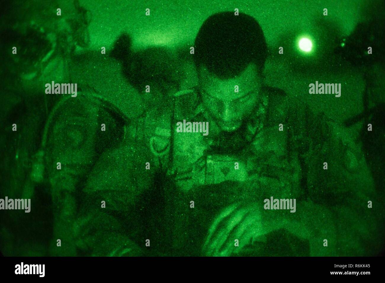 A U.S. Soldier assigned to the 1st Battalion, 506th Infantry Regiment, 1st, Brigade Combat Team, 101st Airborne Division rests after a Night Live Fire Exercise during United Accord 2017 at Bundase Training Camp, Bundase, Ghana, May 26, 2017. United Accord (formerly Western Accord) 2017 is an annual, combined, joint military exercise that promotes regional relationships, increases capacity, trains U.S. and Western African forces, and encourages cross training and interoperability. Stock Photo