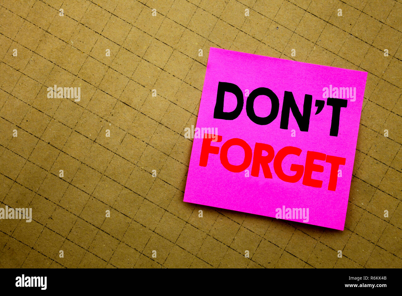 Handwritten text caption showing Do Not Forget. Business concept writing for Don t memory Remider written on sticky note paper on the yellow background. Stock Photo