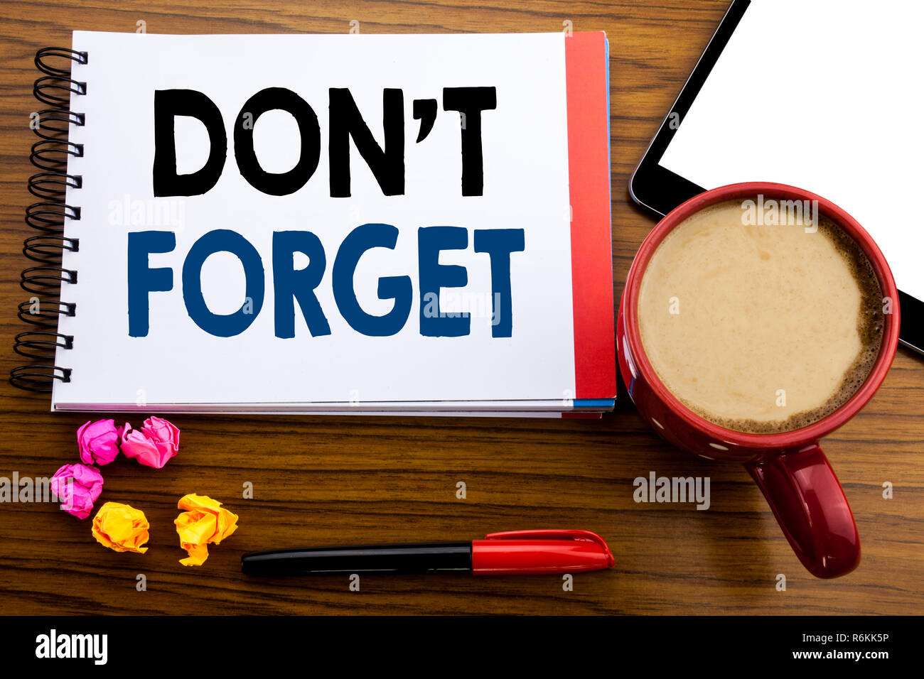 Handwritten text showing Do Not Forget. Business concept writing Don t memory Remider Written on notepad note paper, old black wooden background in office view with pen coffee and tablet Stock Photo