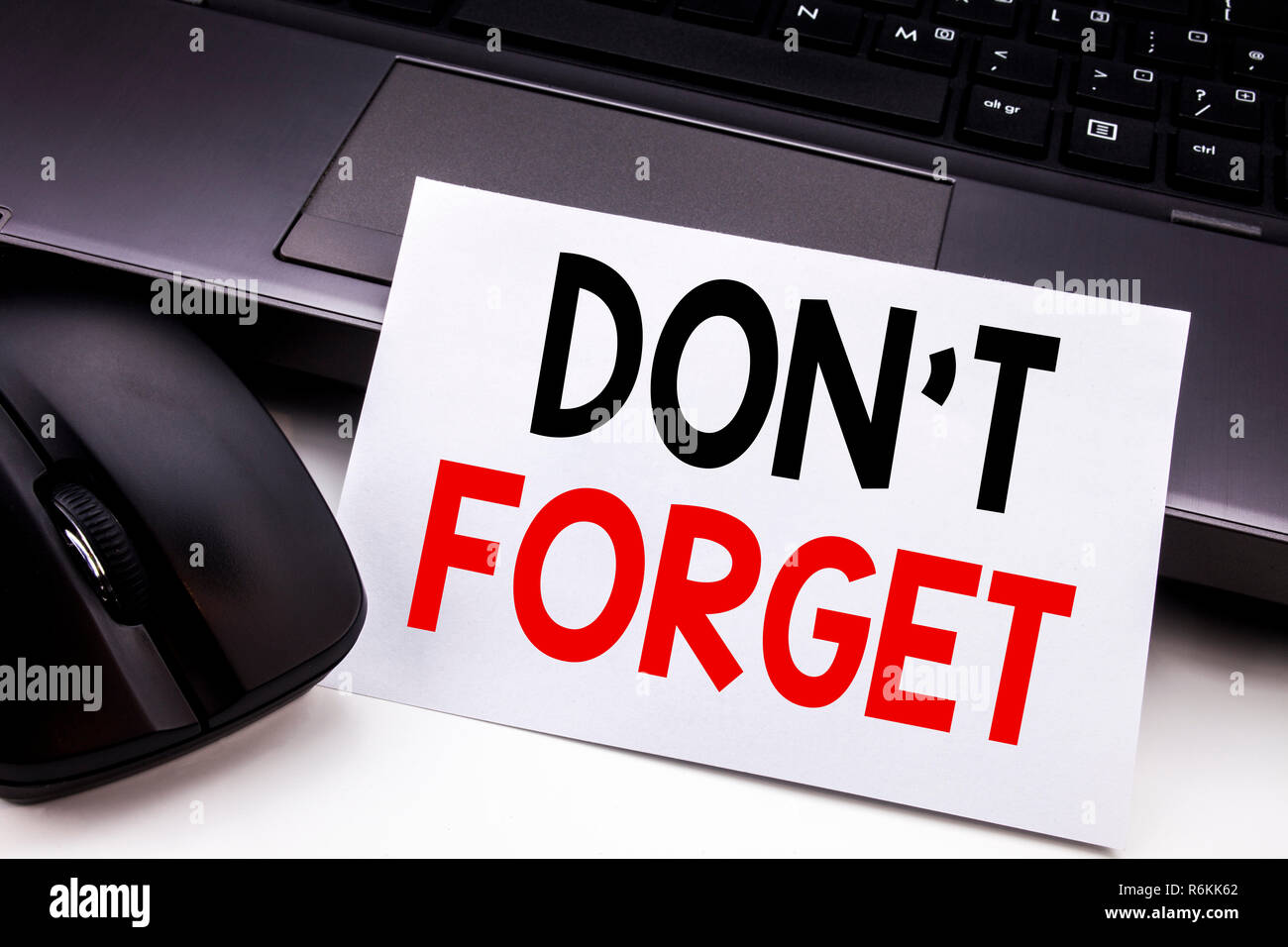 Conceptual hand writing text caption inspiration showing Do Not Forget. Business concept for Don t memory Remider written on sticky note paper on the black keyboard background. Stock Photo