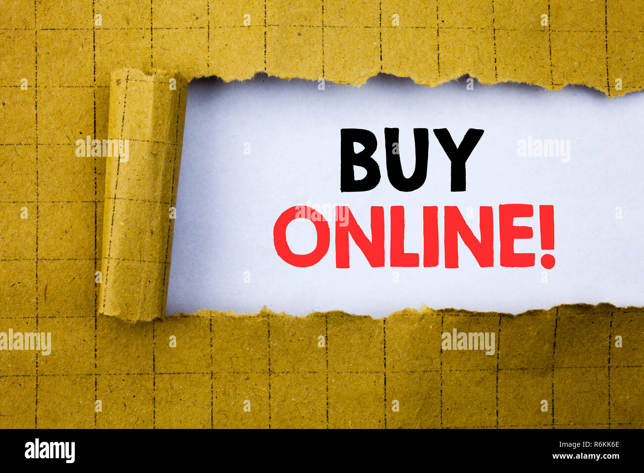 Buy Online. Business concept for E-commerce Sale Purchase written on white paper on the yellow folded paper. Stock Photo