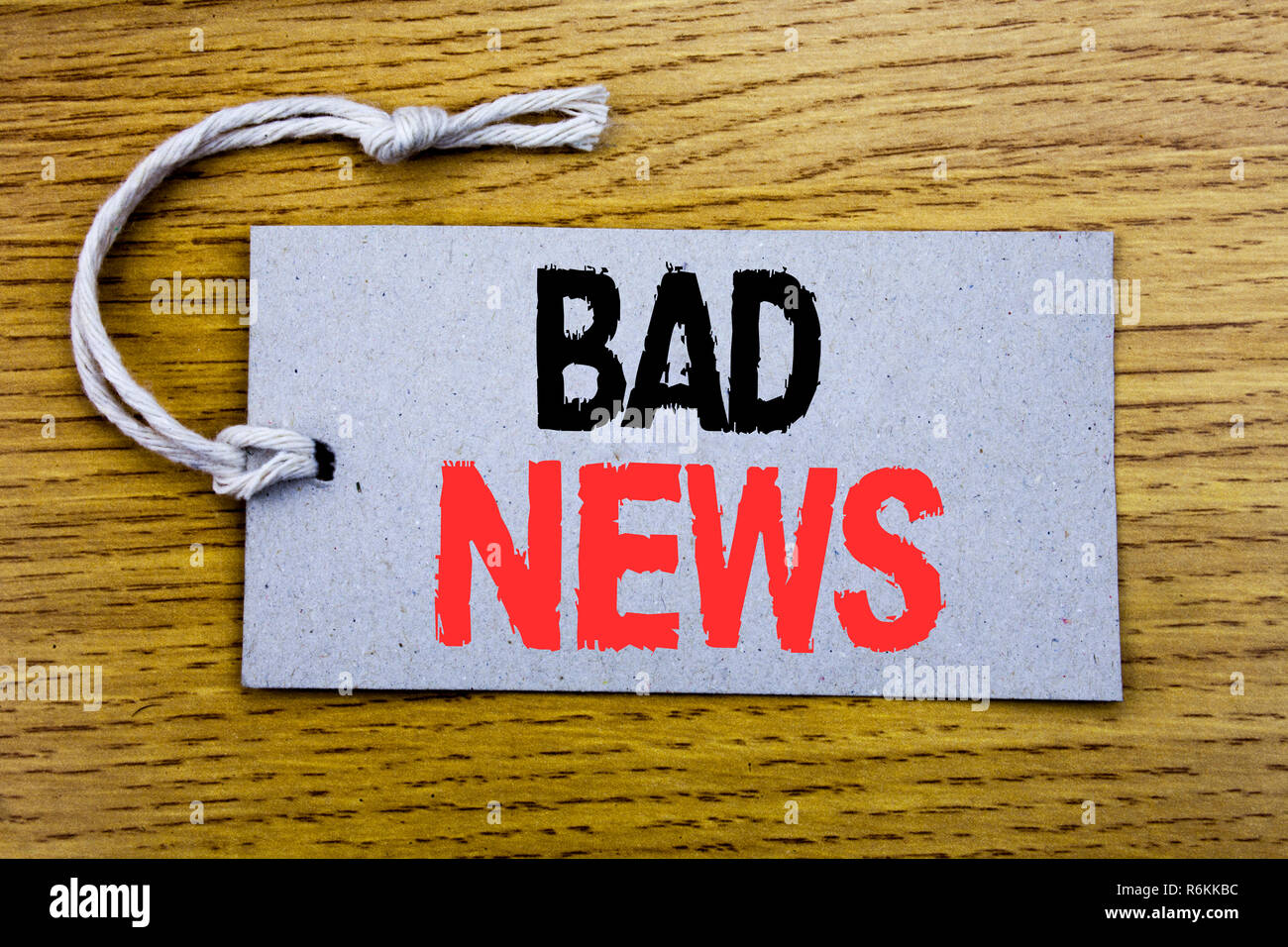 Conceptual hand writing text caption showing Bad News. Business concept for Failure Media Newspaper written on price tag paper with copy space on the wooden vintage background Stock Photo