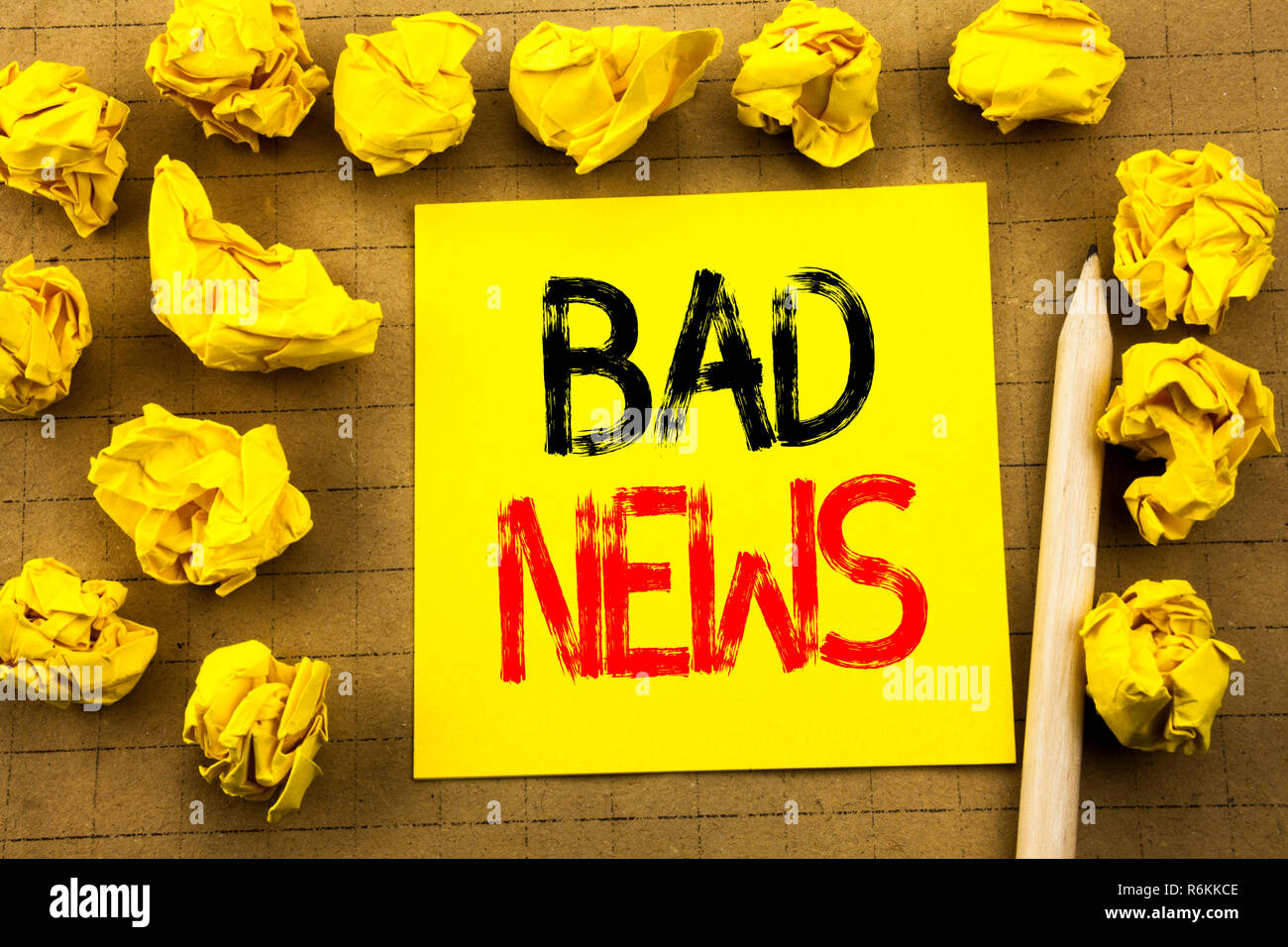 Bad News. Business concept for Failure Media Newspaper written on sticky note paper on the vintage background. Folded yellow papers on the background Stock Photo