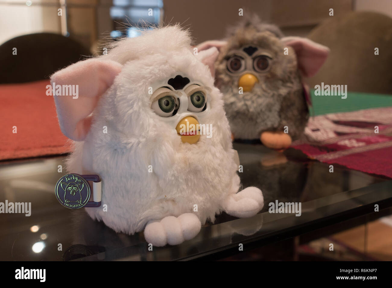 Original Furby and Furby baby (white), must-have intelligent speaking toys from 1998 and 1999 (baby), made by Tiger electronics, await conversation. Stock Photo