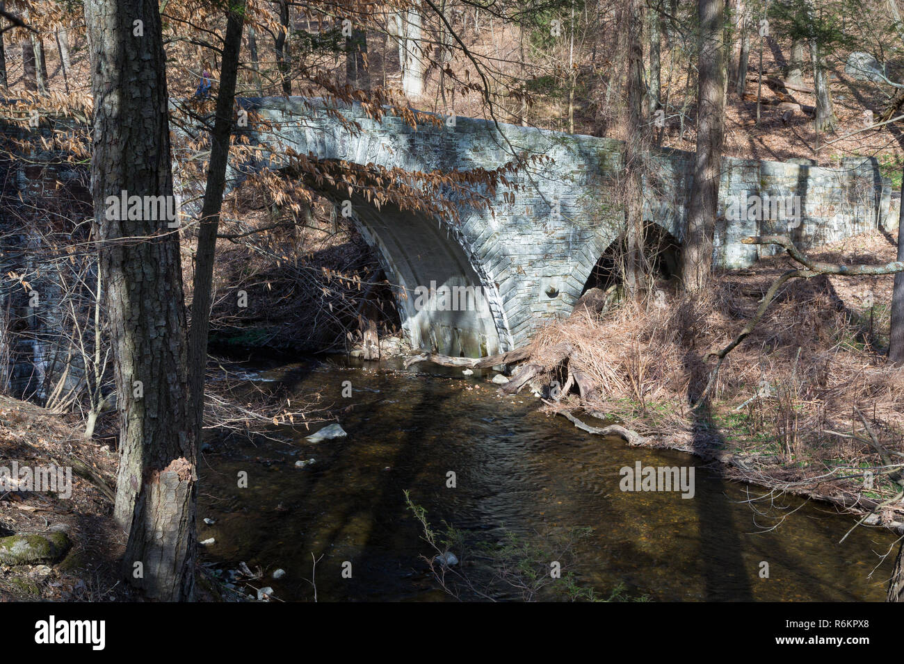 An old carriage road bridge with three arches passing over the