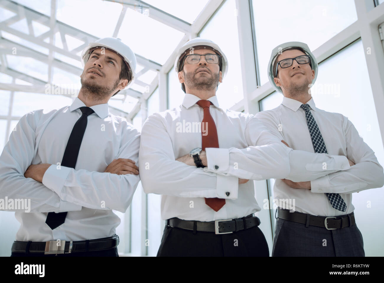 three architects standing in an empty office Stock Photo