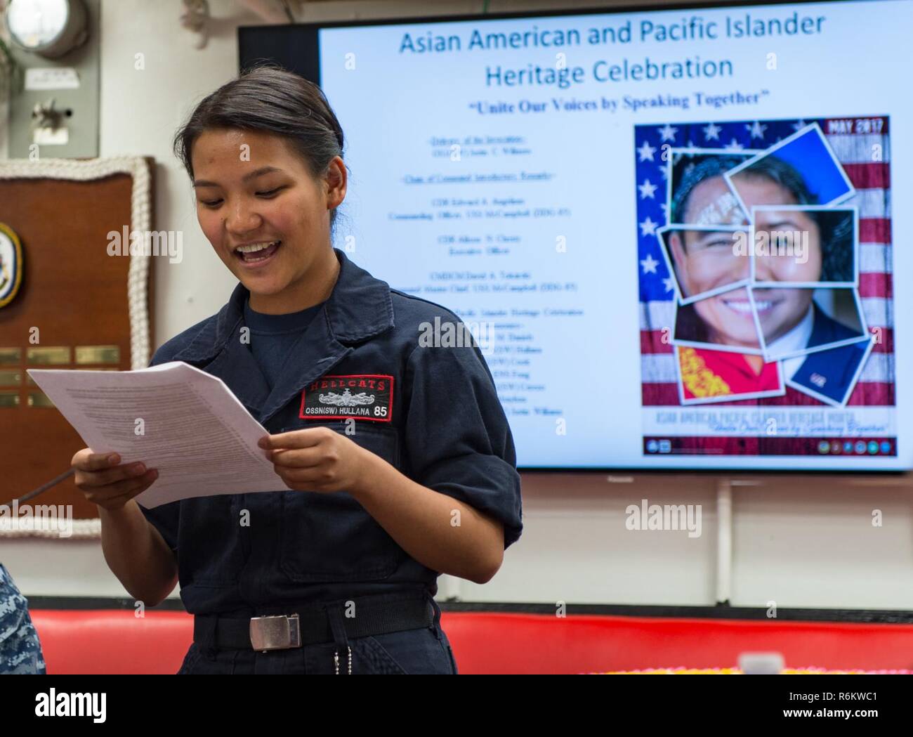 WATERS SOUTH OF JAPAN (May 21, 2017) Operations Specialist Seaman Jo Yedda Hullana, assigned to the Arleigh Burke-class guided-missile destroyer USS McCampbell (DDG 85), gives a speech during a Asian American and Pacific Islander Heritage Month celebration. McCampbell is on patrol in the U.S. 7th Fleet area of operations in support of security and stability in the Indo-Asia-Pacific region. Stock Photo