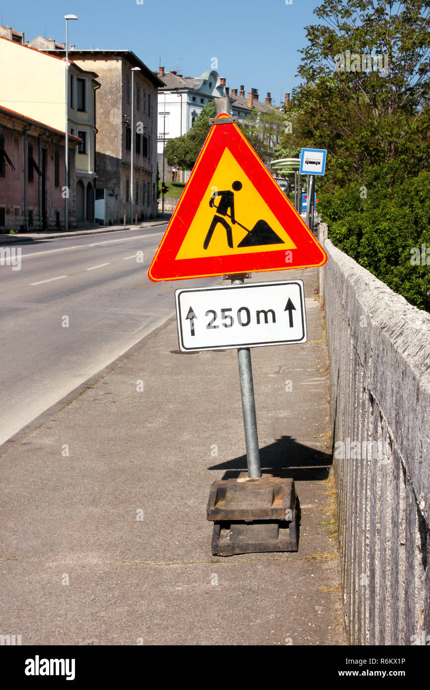 Road works sign for construction works in city street. Road under