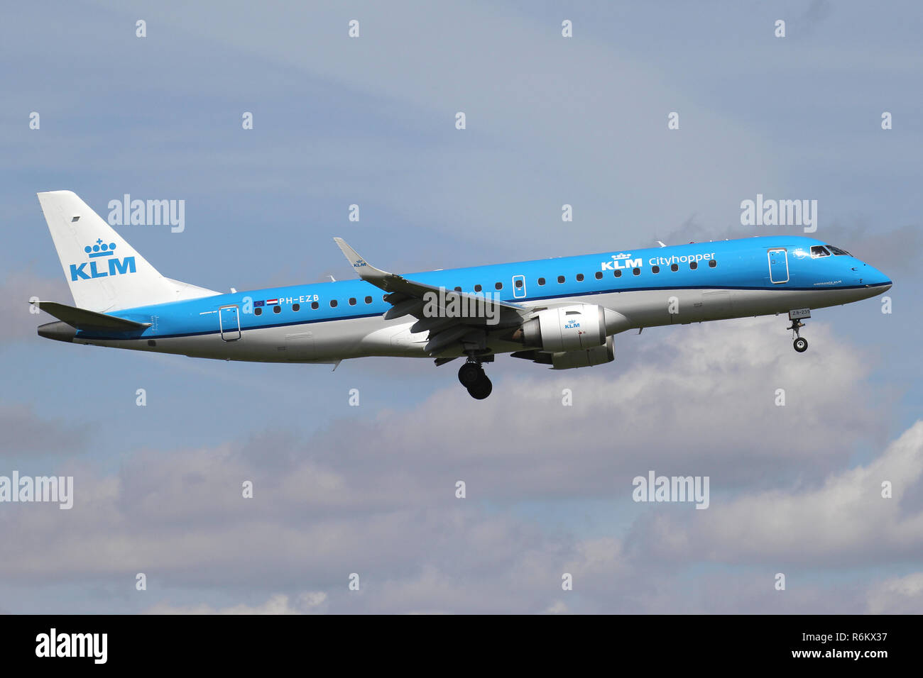 Dutch KLM cityhopper Embraer ERJ-190 with registration PH-EZB on short final for runway 06 of Amsterdam Airport Schiphol. Stock Photo