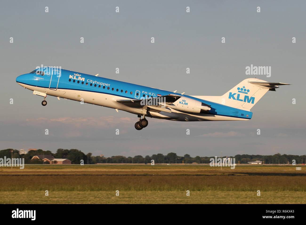 Dutch KLM Cityhopper Fokker 70 with registration PH-KZL just airborne at Amsterdam Airport Schiphol. Stock Photo