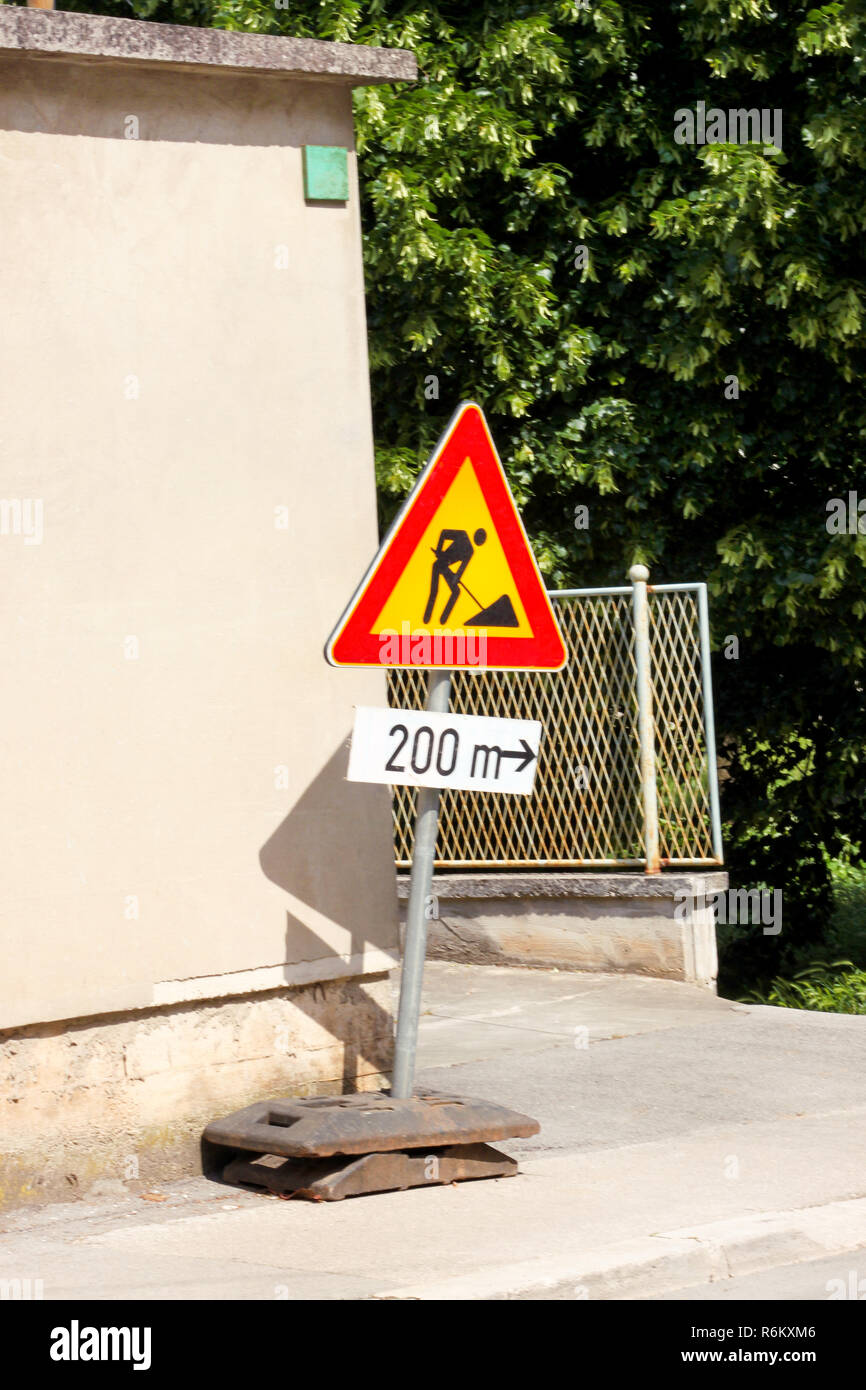 Road works sign for construction works in city street. Road under ...