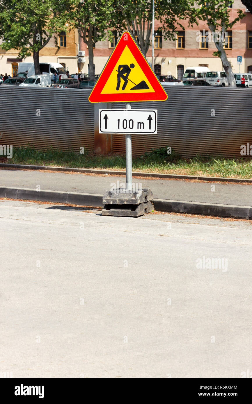 Road works sign for construction works in city street. Road under