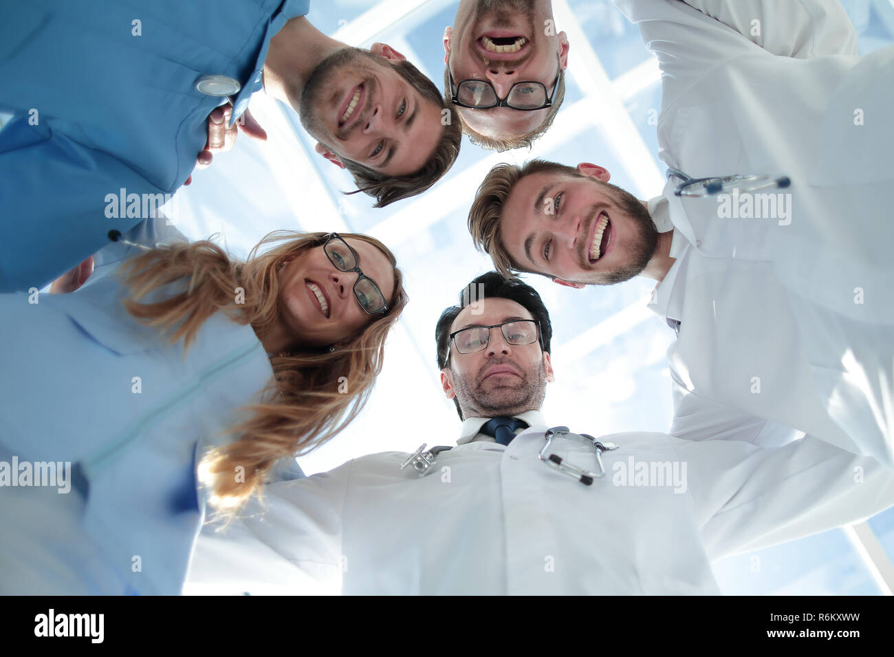 doctors looking down smiling at the camera Stock Photo - Alamy