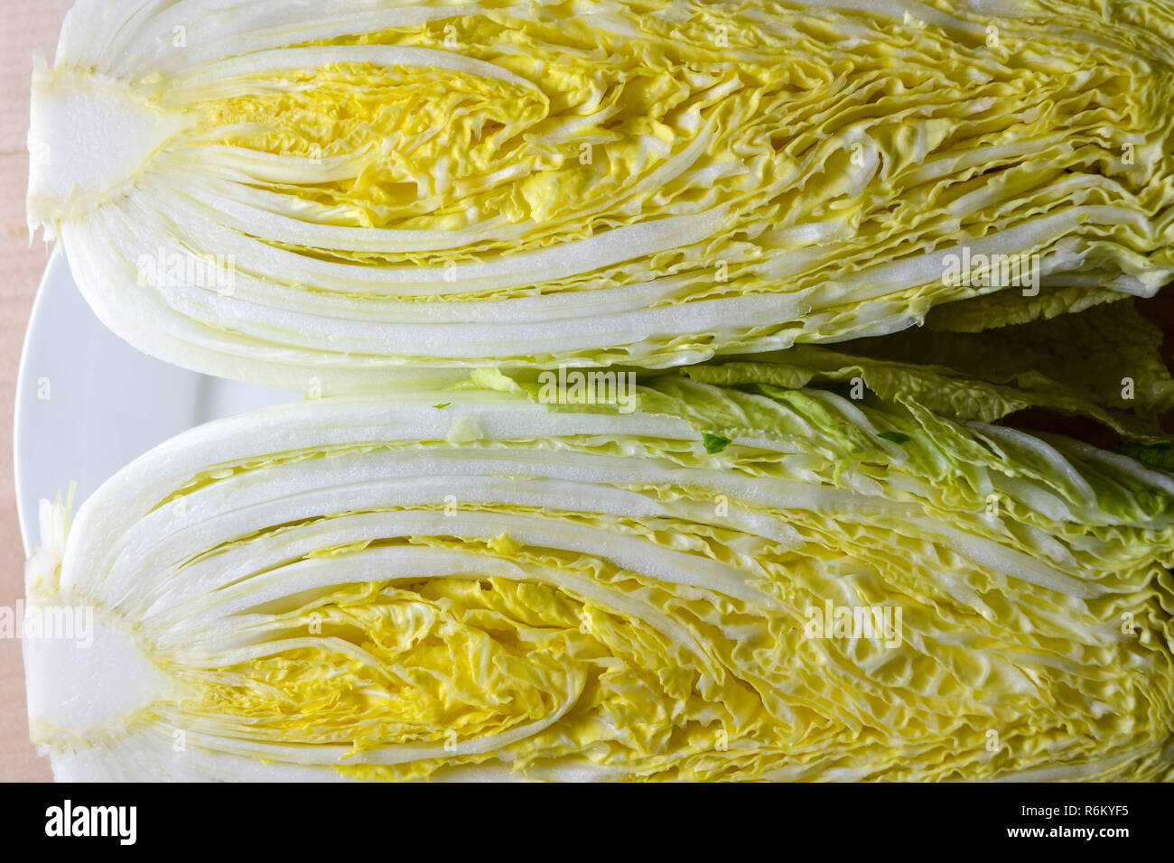 Chinese napa cabbage shown in cross-section, shot top-down (flat-lay). Stock Photo