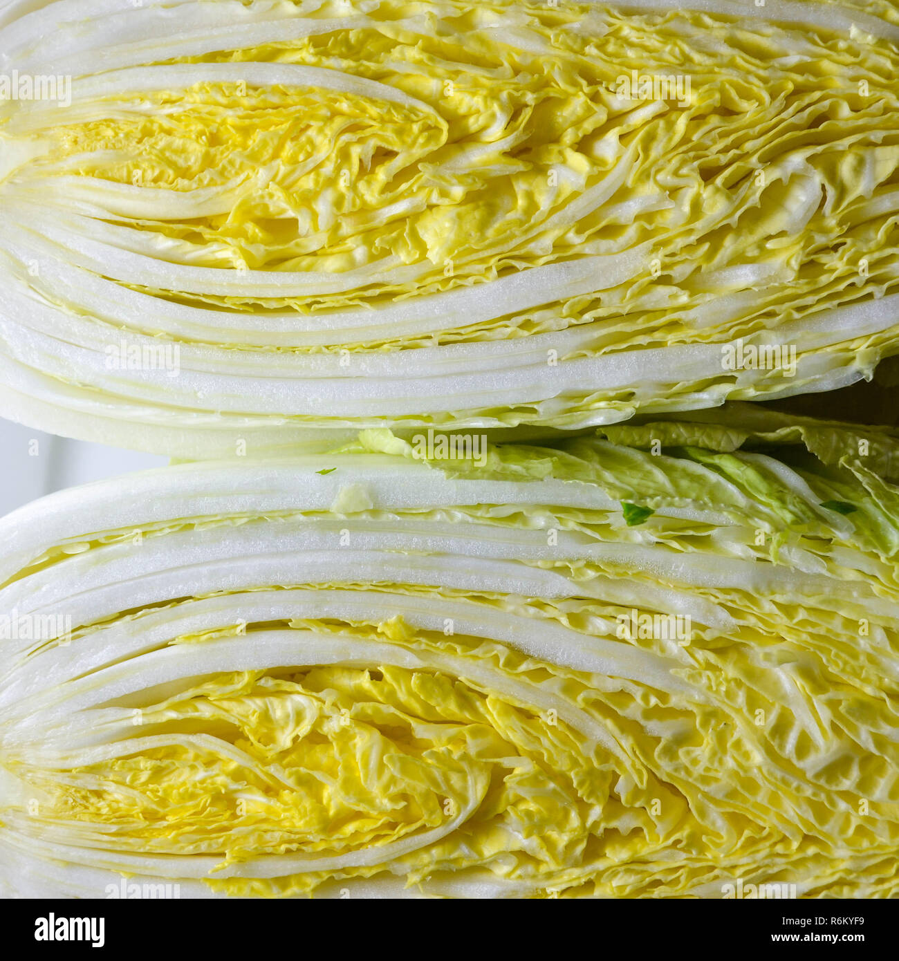 Chinese napa cabbage shown in cross-section, shot top-down (flat-lay). Stock Photo