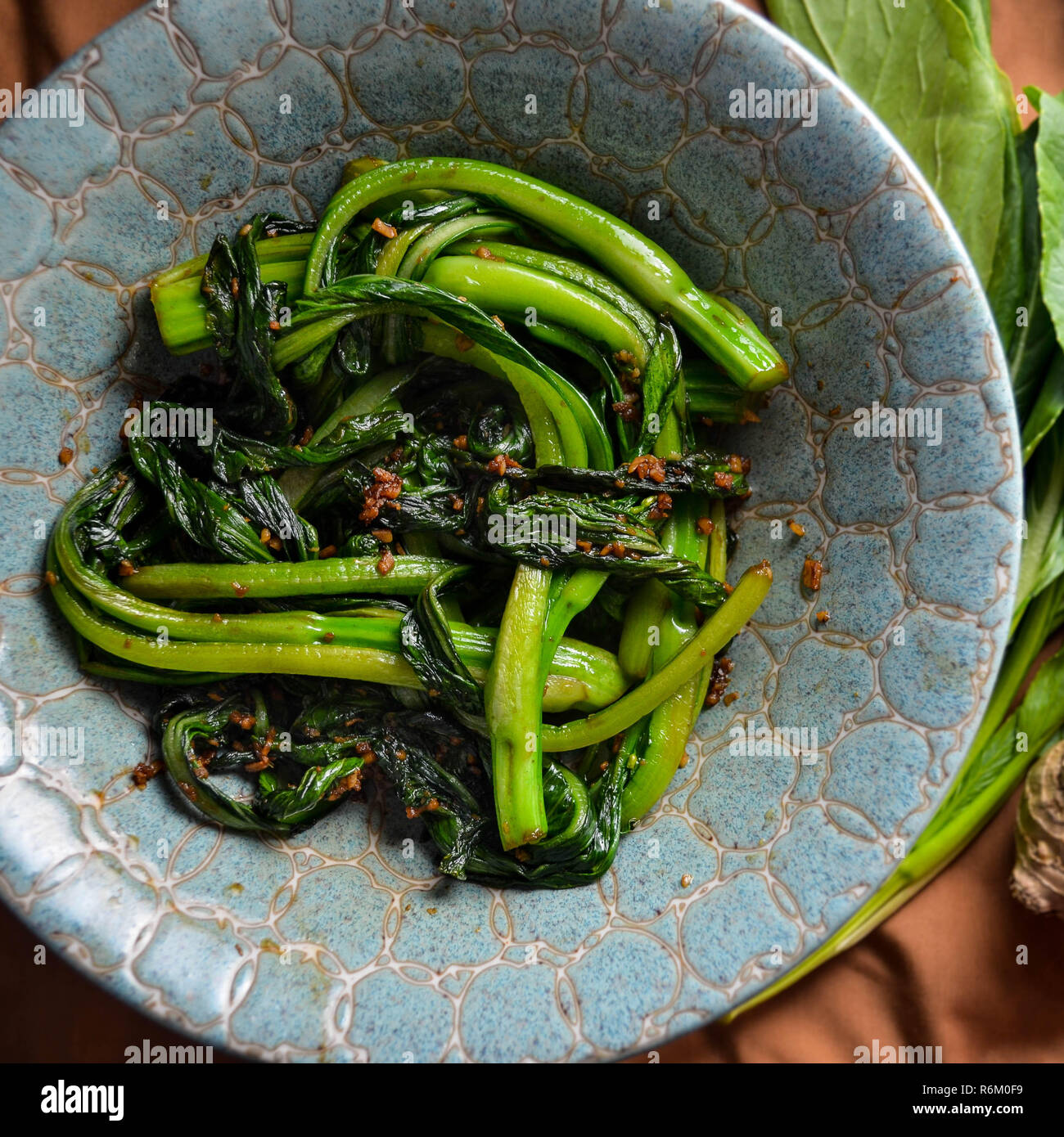 Stir-fried Choy Sum (caixin) with garlic and ginger (Chinese cooking) Stock Photo