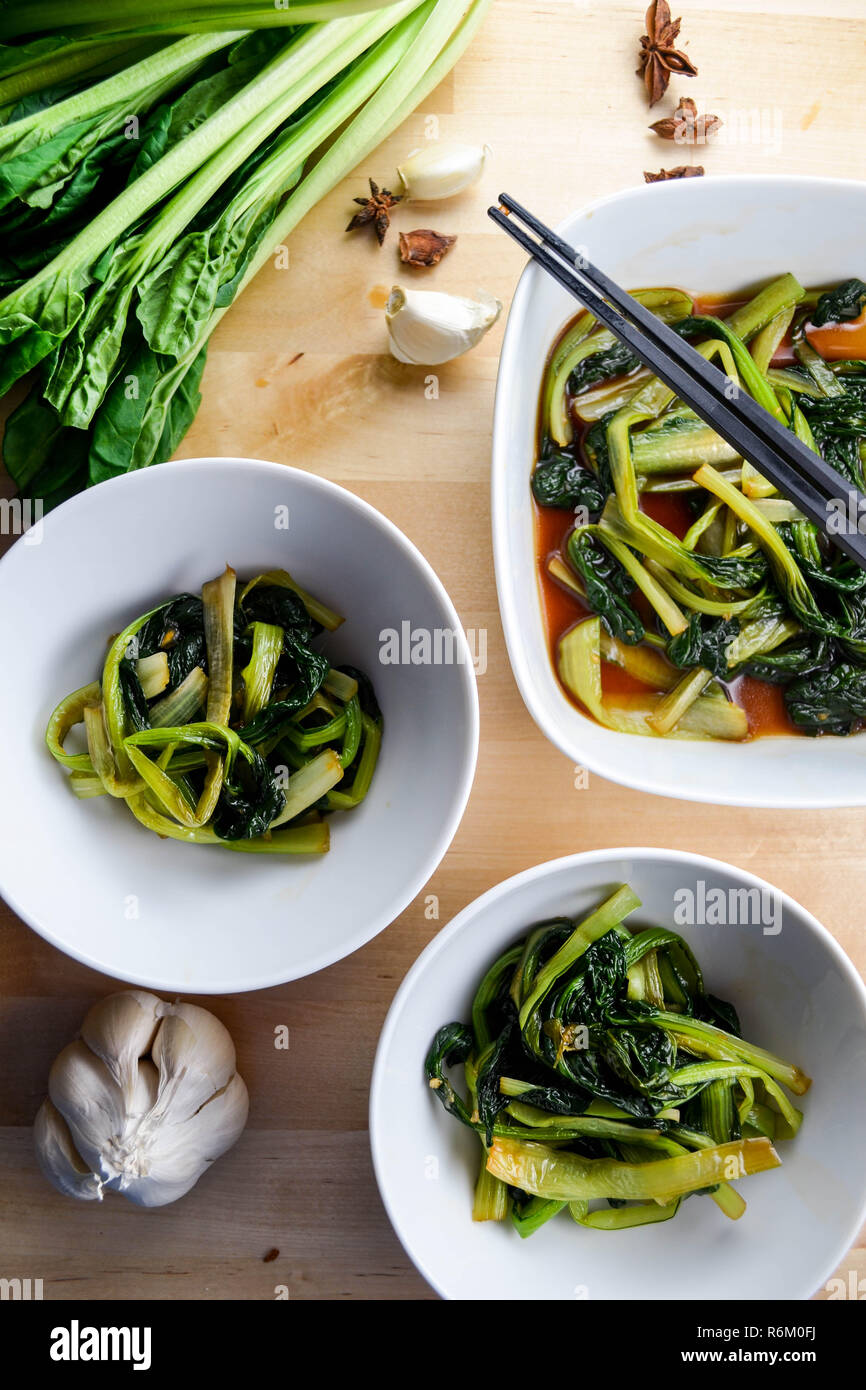 Braised bok choy with garlic, soy sauce, and star anise (Chinese cooking) Stock Photo