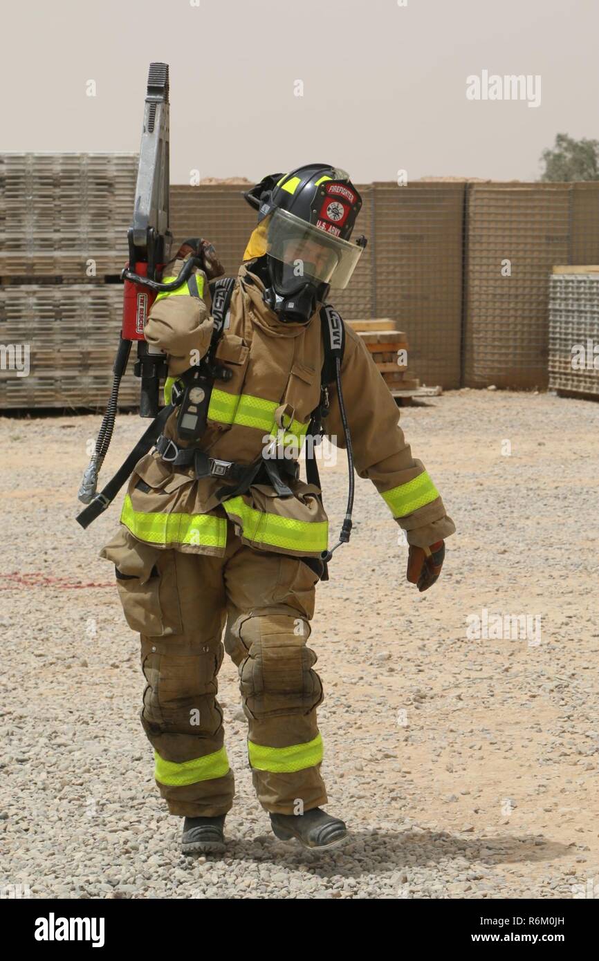 A U.S. Army Soldier, deployed in support of Combined Joint Task Force-Operation Inherent Resolve, competes in a firefighters’ physical training challenge at Qayyarah West Airfield, Iraq, May 19, 2017. The Soldier, assigned to the “Q-West” firefighters team consisting of members from the 562nd Firefighter Detachment and 514th Firefighter Detachment helped create this challenge to bring different units on Qayyarah West Airfield together and promote physical fitness. CJTF-OIR is the global Coalition to defeat ISIS in Iraq and Syria. Stock Photo