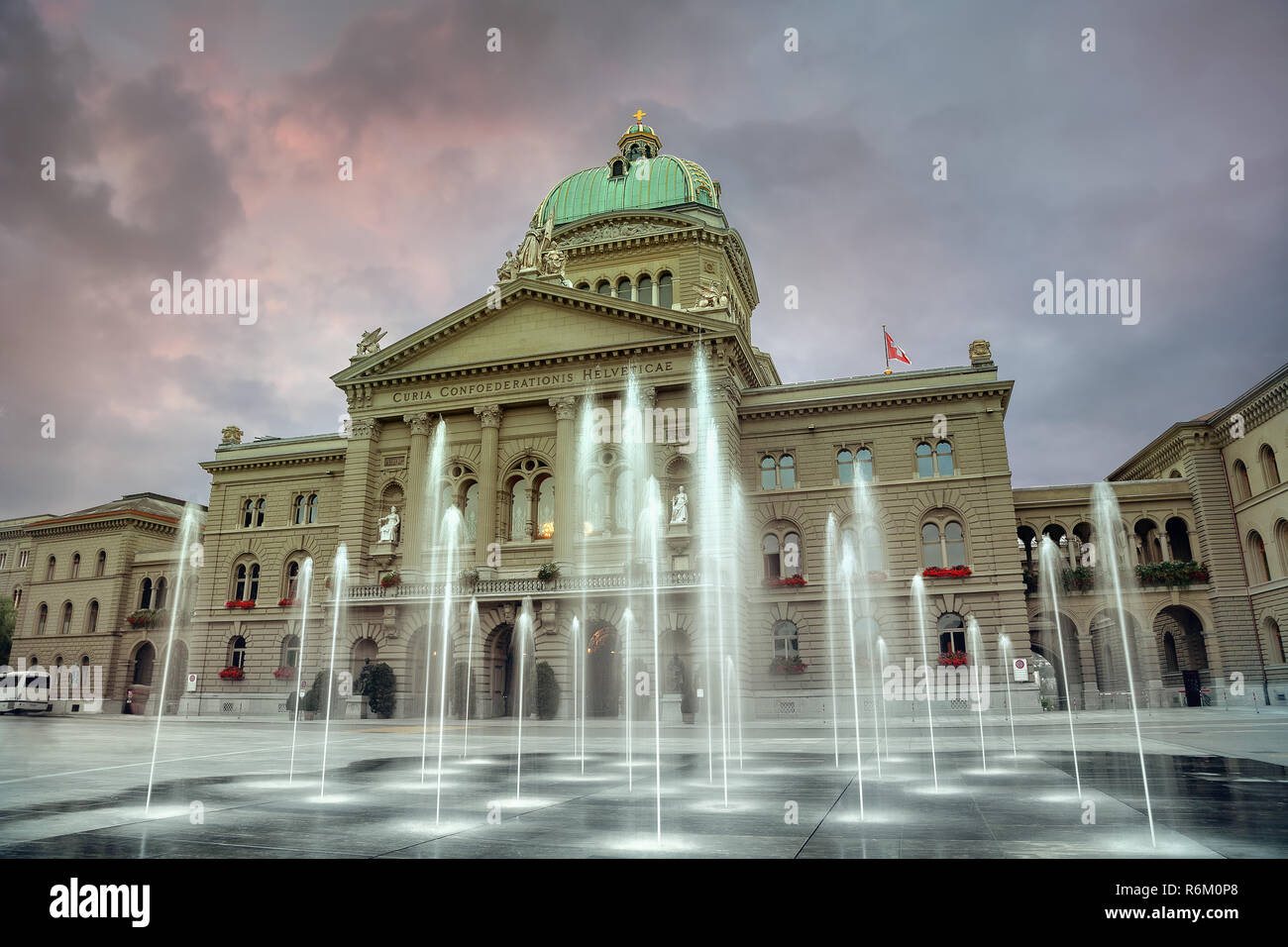 Swiss Federal Parliament and Parliament square with fountain at evening time. Bern. Switzerland Stock Photo