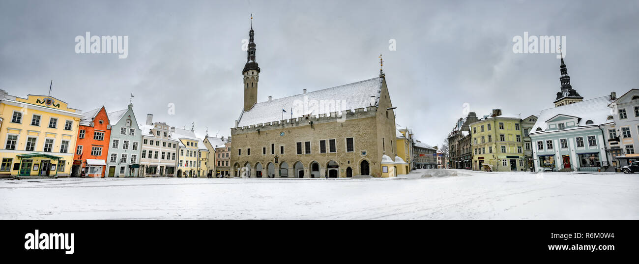 Panoramic landscape with Town Hall building and houses in Raekoja square at winter snowy day. Tallinn, Estonia Stock Photo