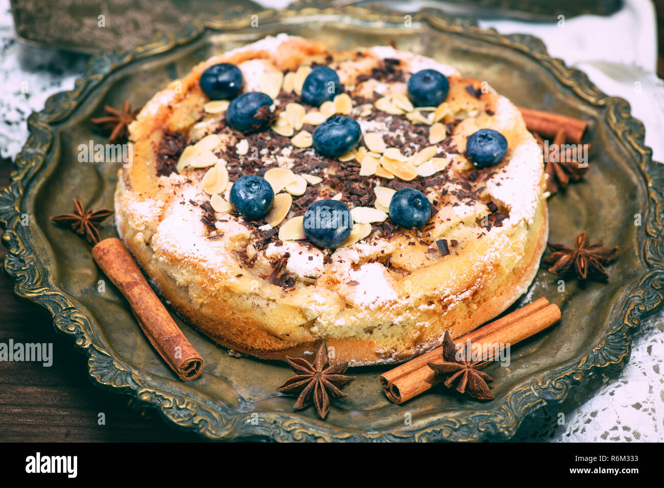 baked round cake with blueberry berries on a copper plate Stock Photo
