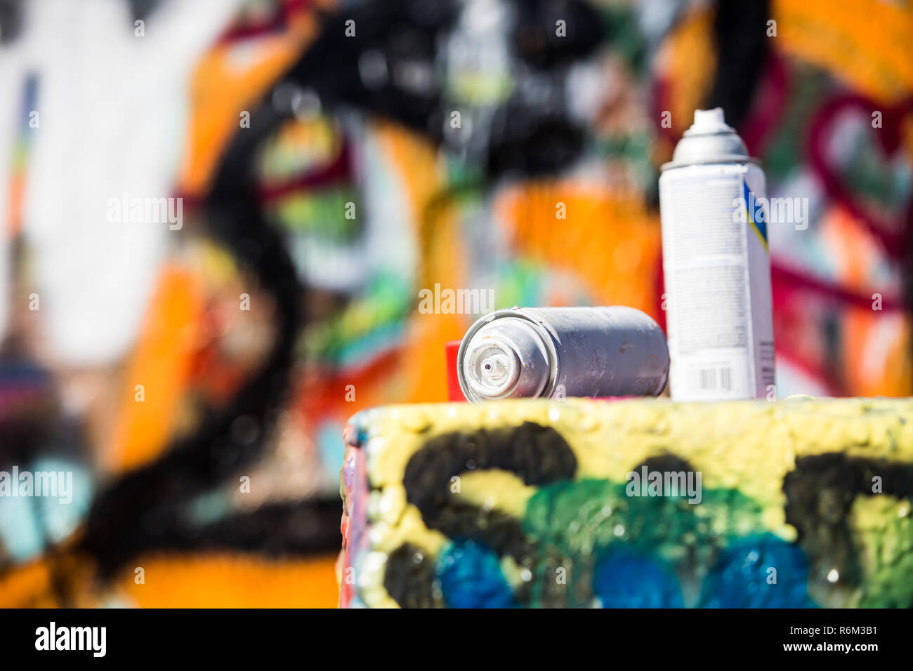 Two Discarded Spray Cans in Front of Graffiti Wall Stock Photo - Alamy