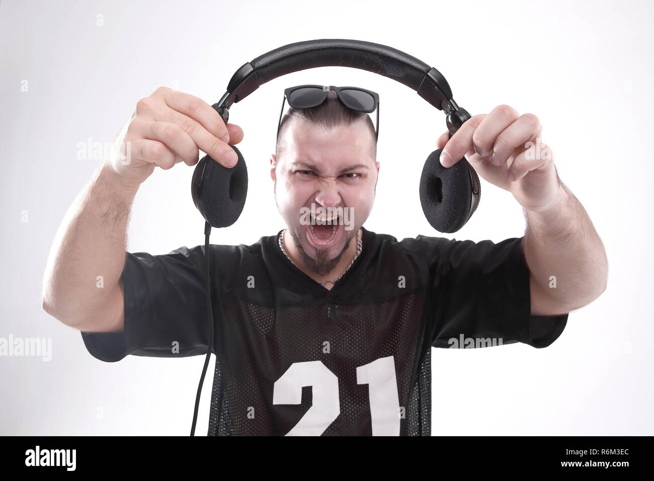 close up. stylish rapper shows headphones .isolated on white Stock ...