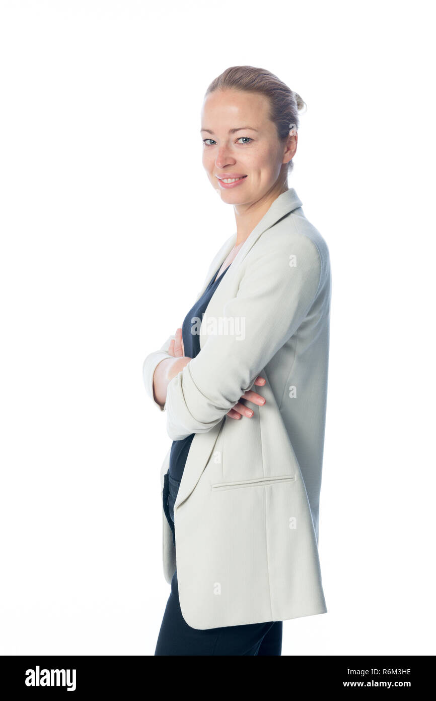 Business woman standing with arms crossed against white background. Stock Photo