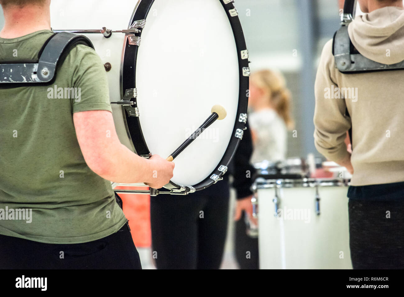 Musicians march, play and make music with large bass drums Stock Photo