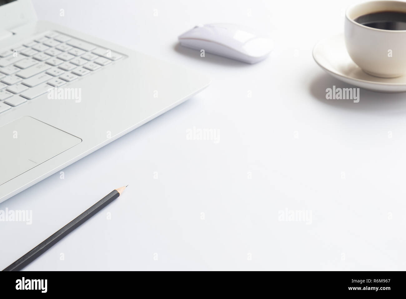 White desk office with laptop, smartphone and other work supplies with cup of coffee. Top view with copy space for input the text. Designer workspace  Stock Photo
