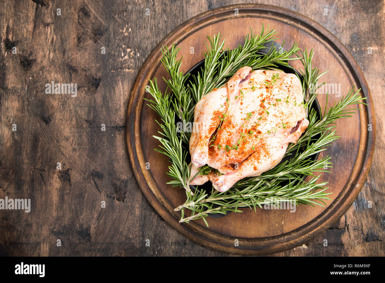whole raw chicken on wooden cutting board. raw chicken carcass with