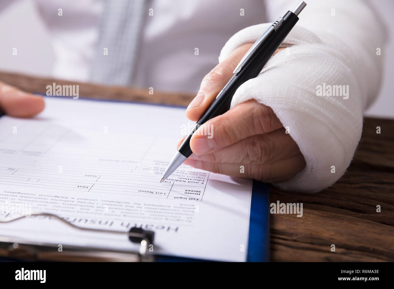 Man With Broken Arm Filling Health Insurance Claim Form Stock Photo Alamy